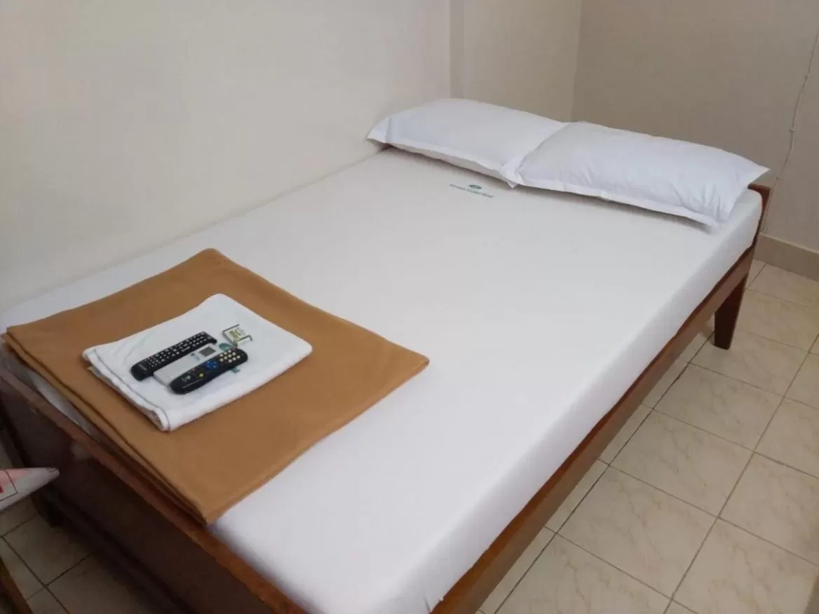 Bed in Anandan Tourist Home