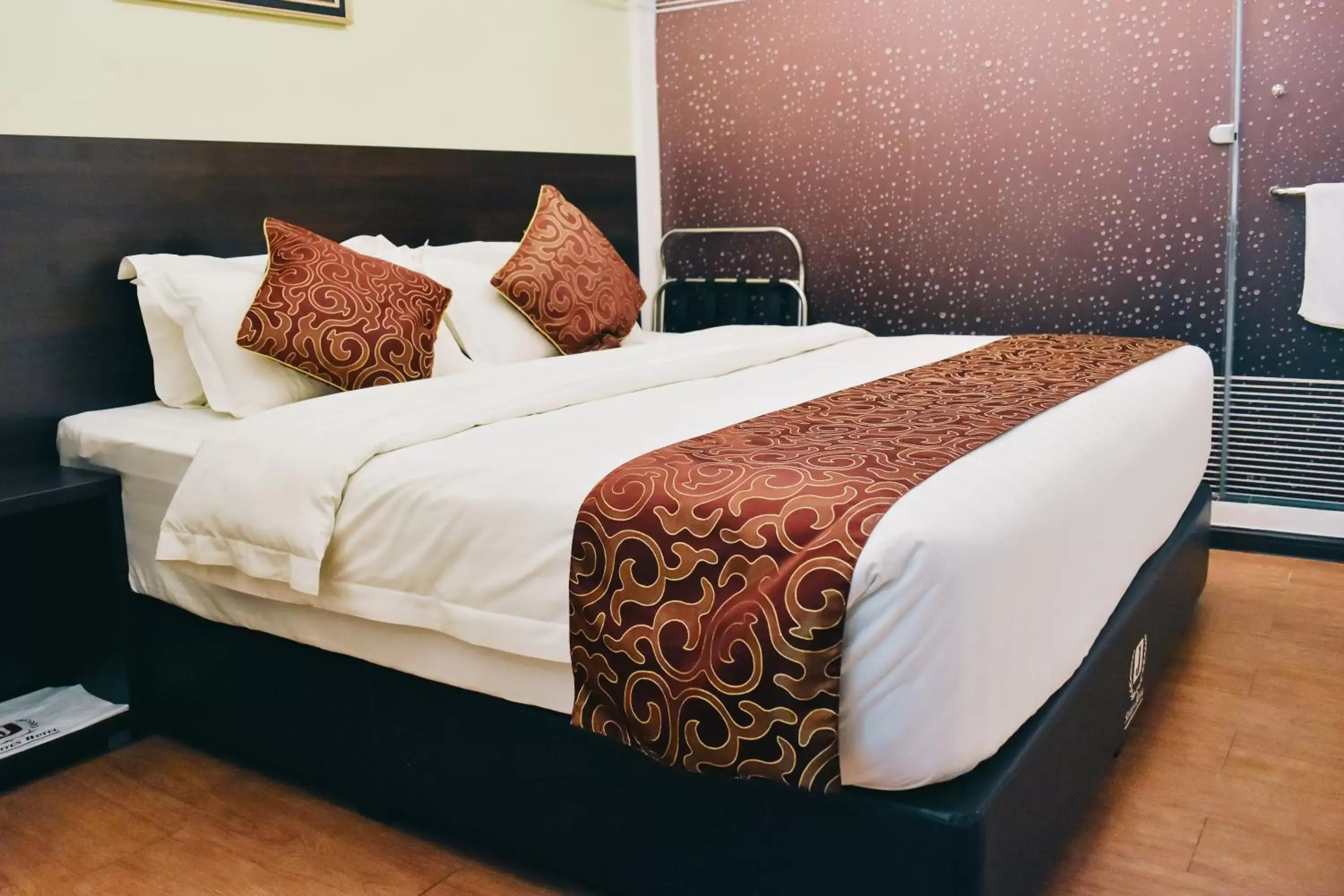 Bed in J Suites Hotel