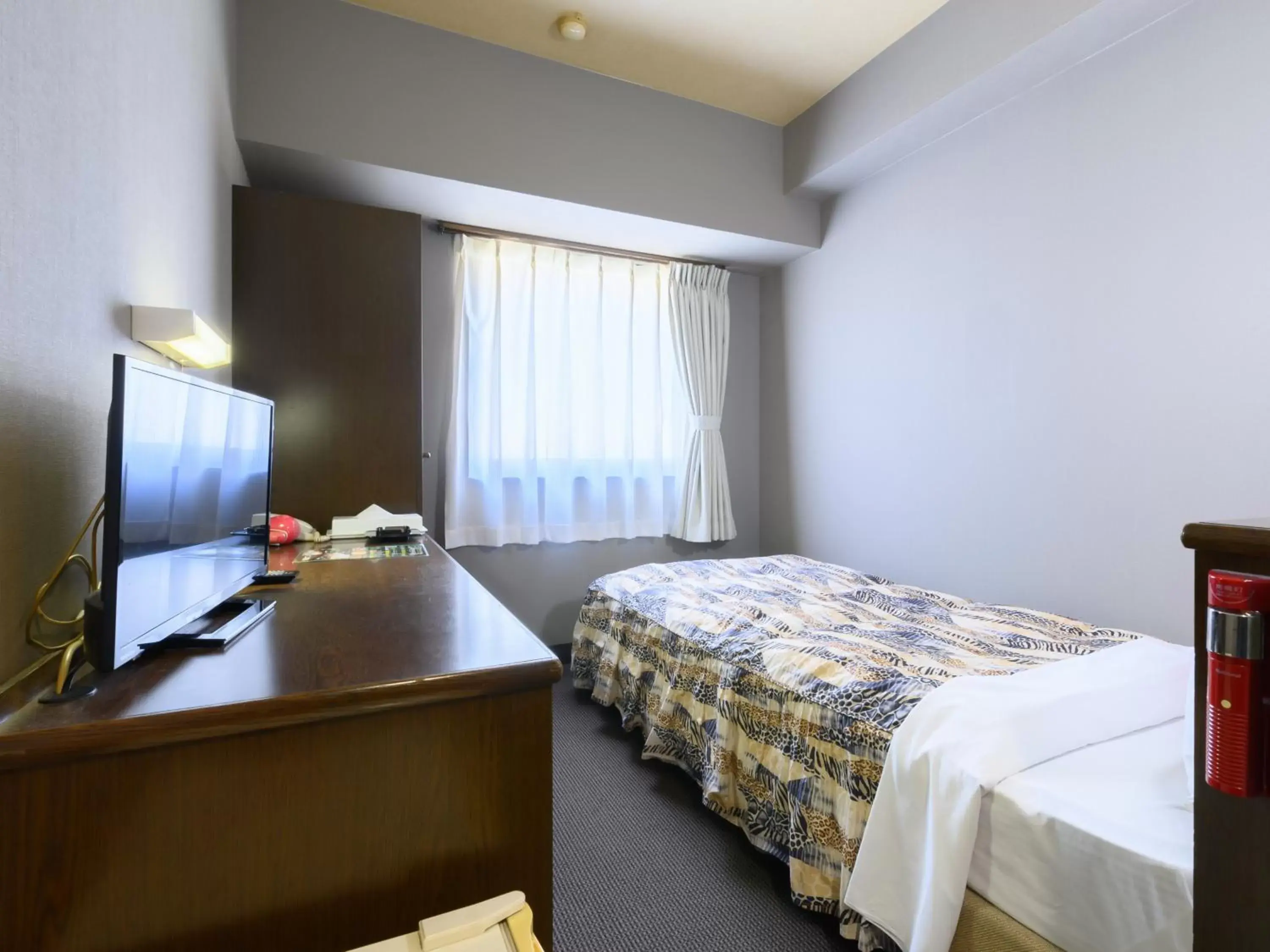 Bed in Tabist IWATA Station Hotel