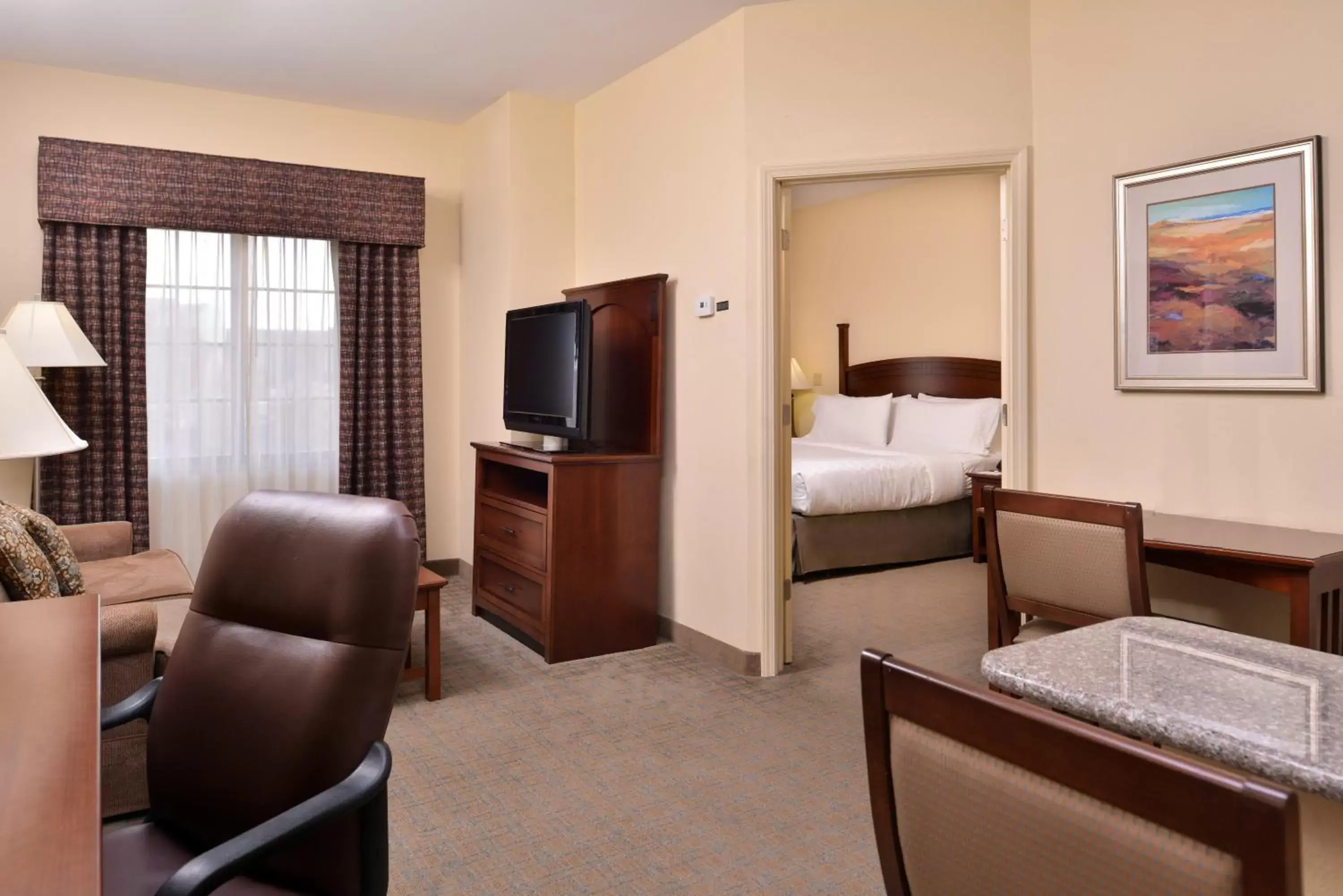 Bedroom, Seating Area in Staybridge Suites Oklahoma City, an IHG Hotel