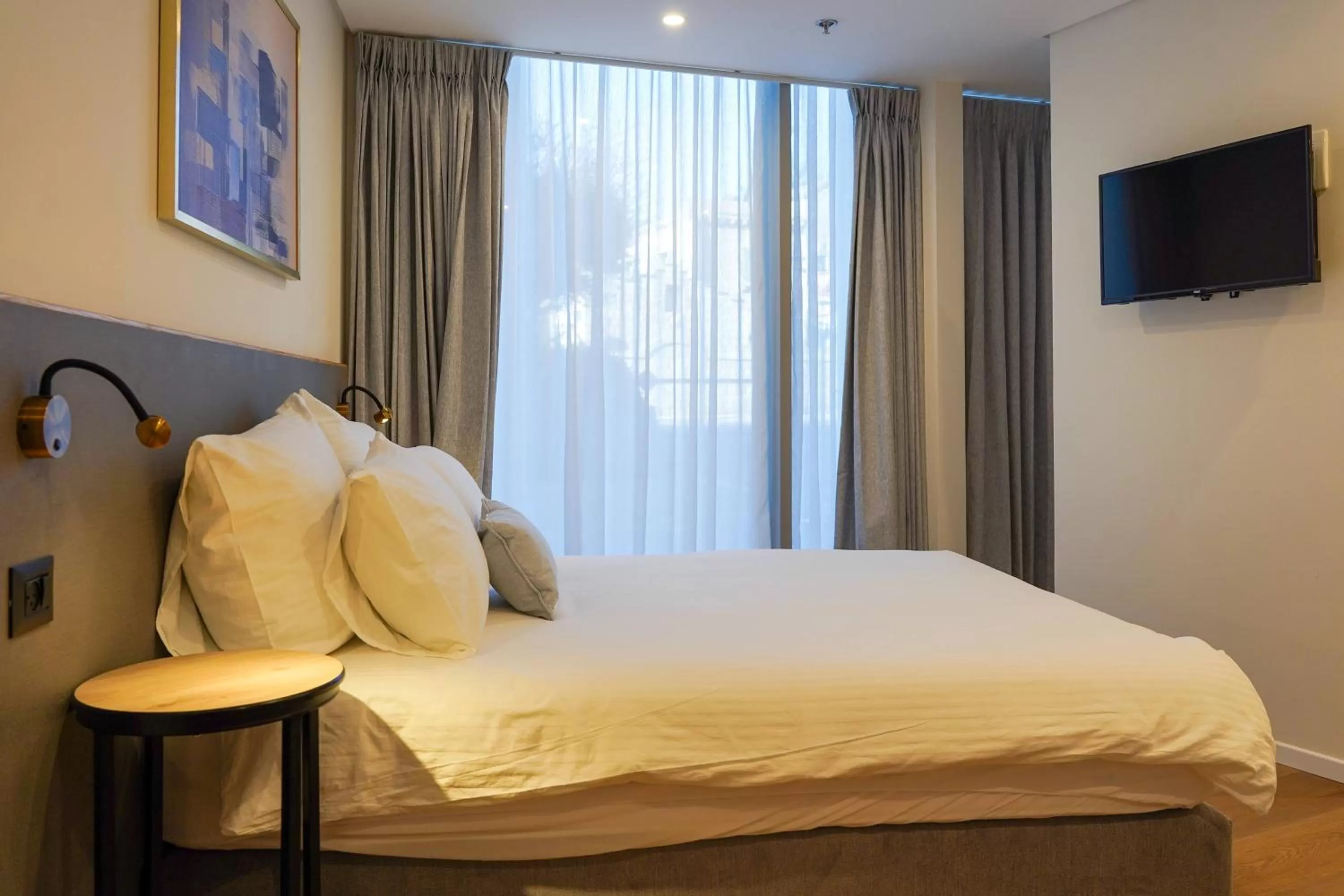 Bed in Urbanic Apartments