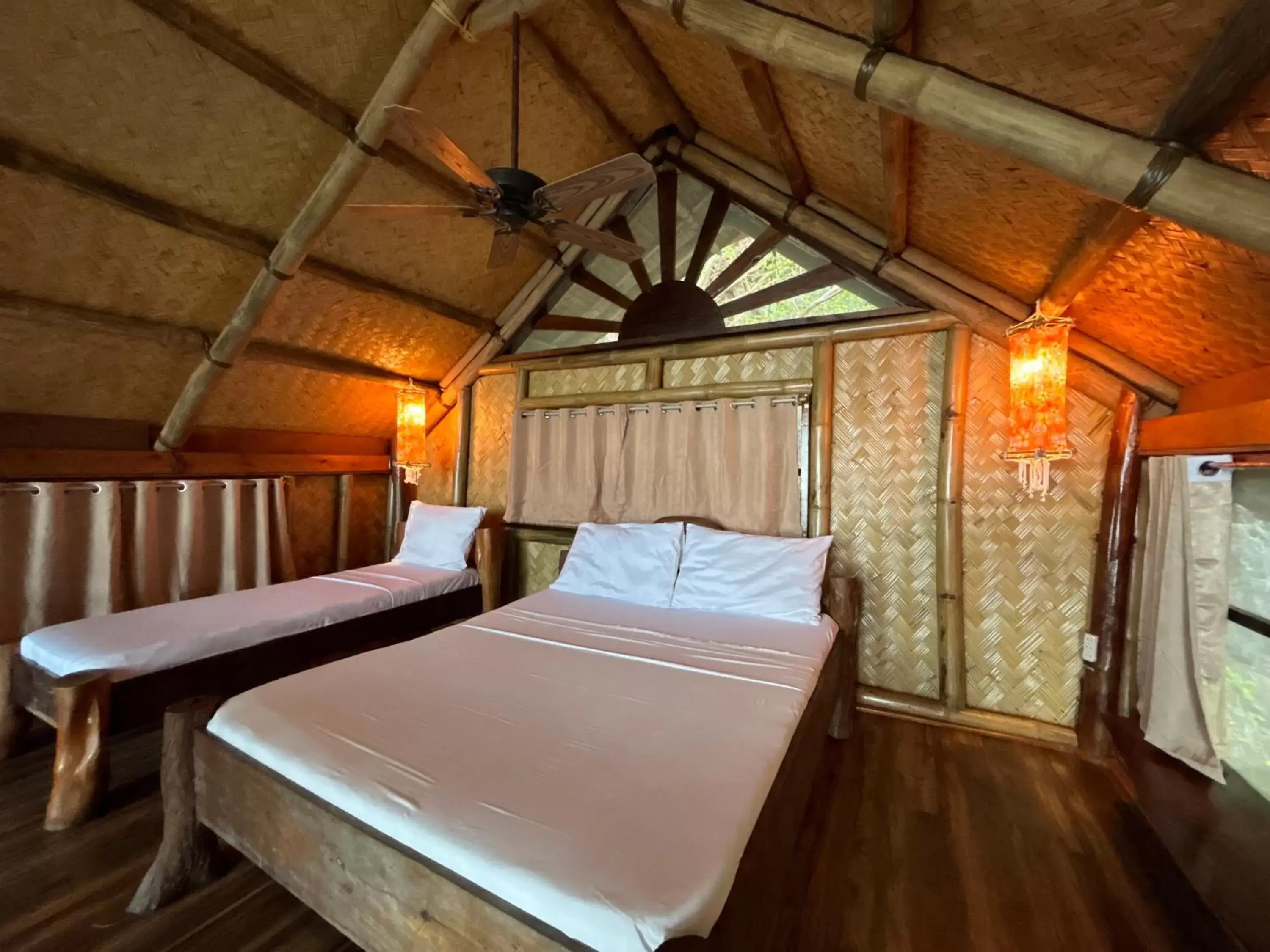 Bed in Sangat Island Dive Resort