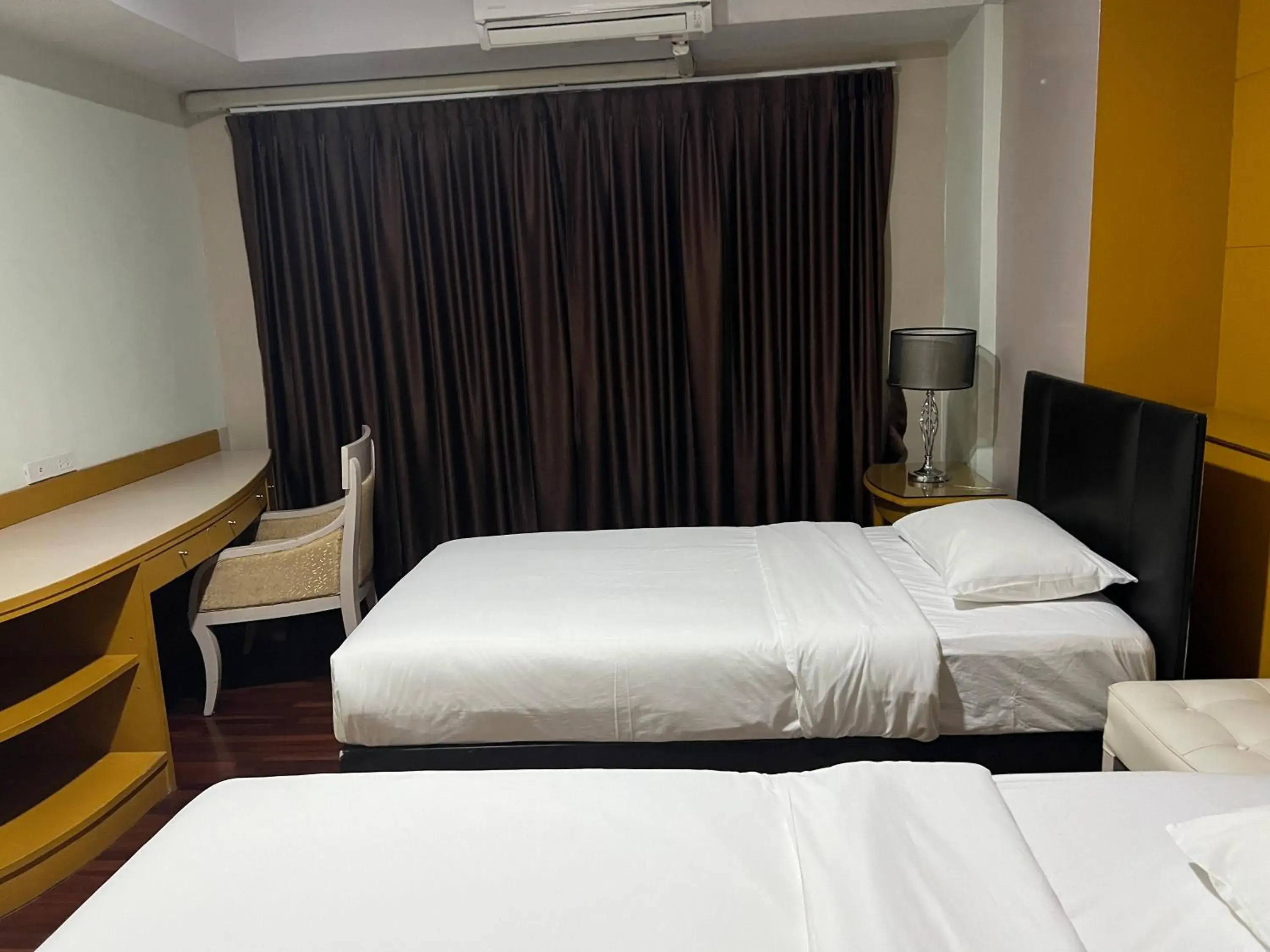 Bed in Mall Suites Hotel