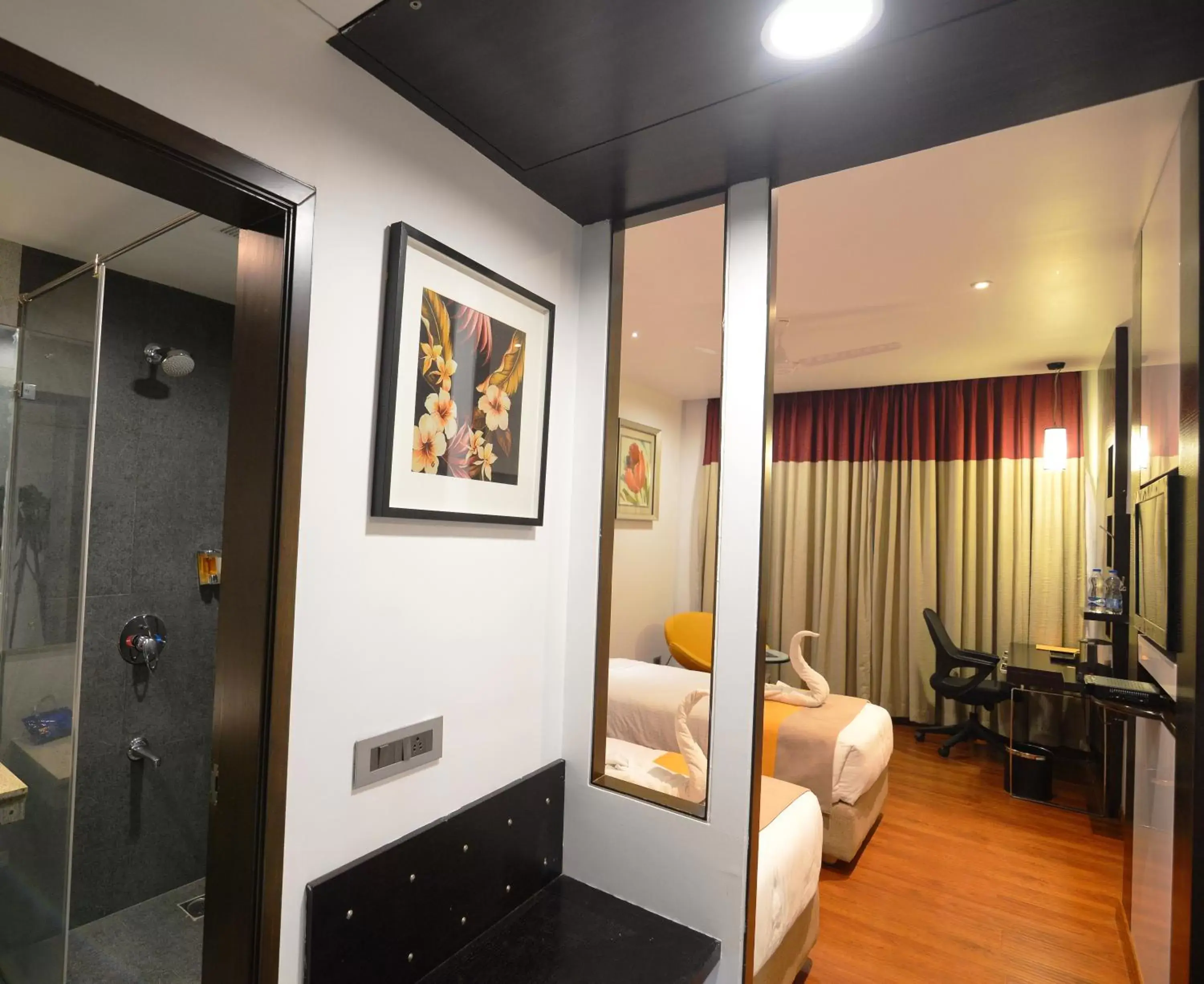 Bed, TV/Entertainment Center in Astoria Hotels Madurai