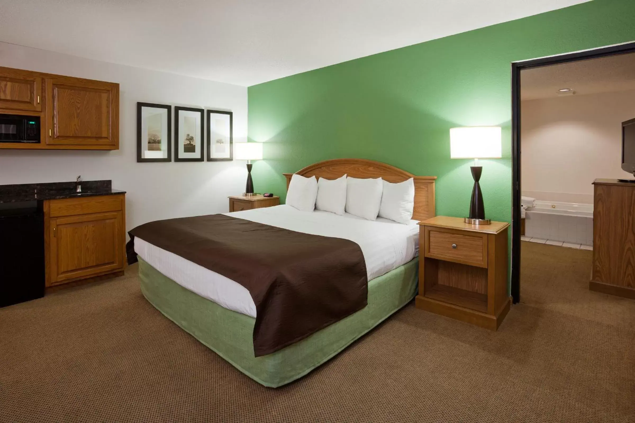 Bed in AmericInn by Wyndham Eau Claire