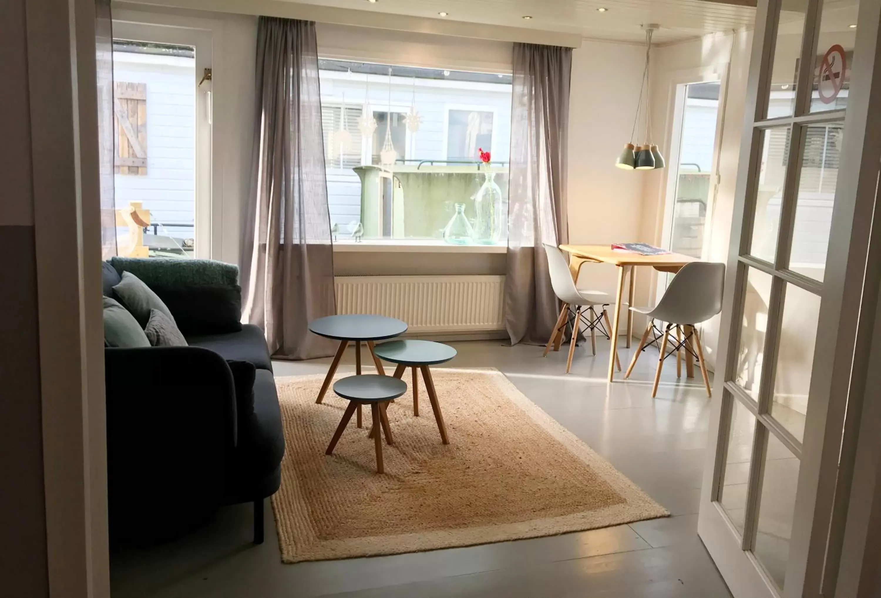 Living room in Houseboat apartment with water terrace, free parking, free bikes & fast wifi