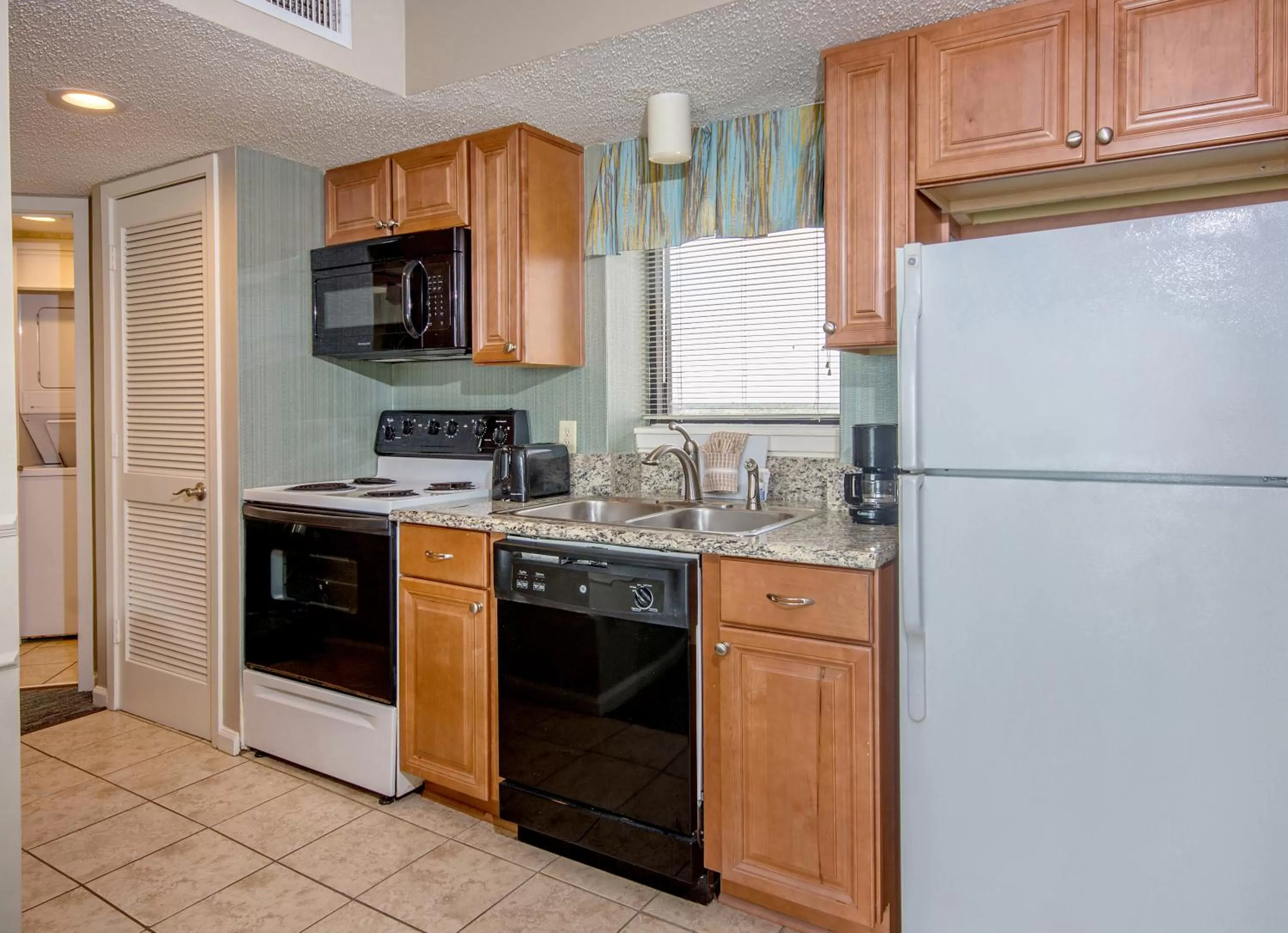 Kitchen or kitchenette in The Strand - A Boutique Resort