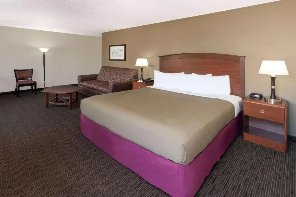 Bed in AmericInn by Wyndham Grundy Center