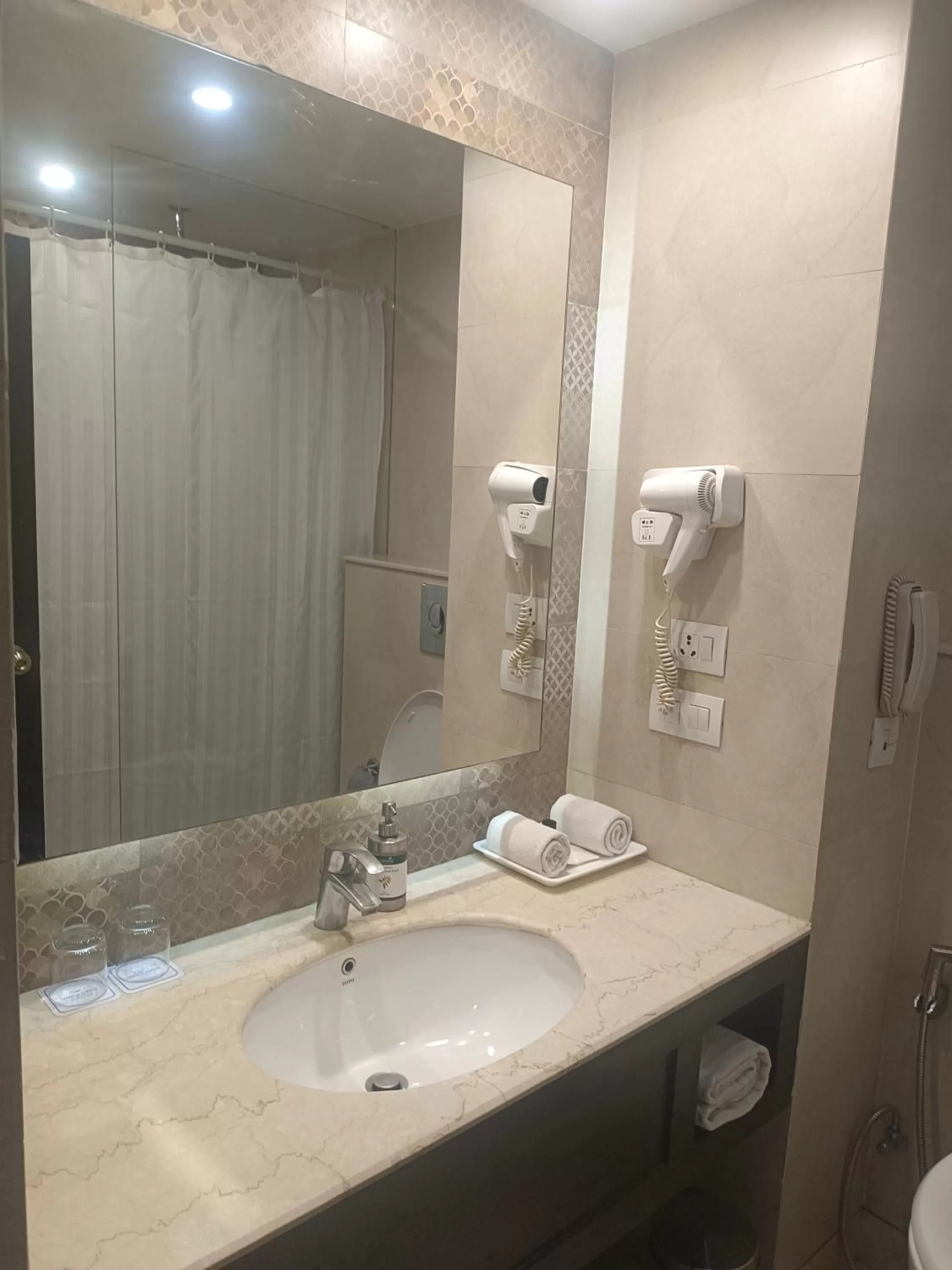 Bathroom in La Place Sarovar Portico