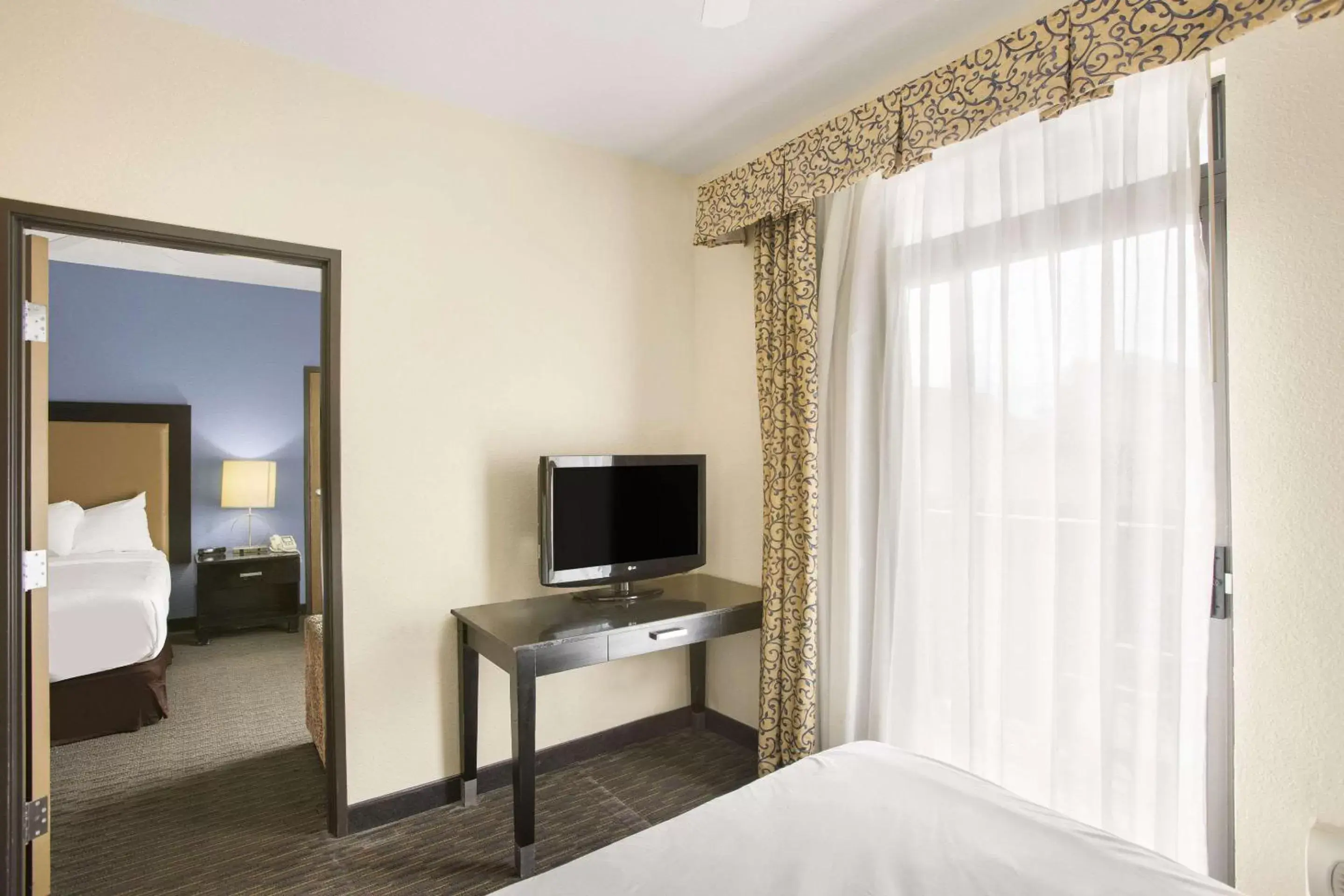 Bedroom, TV/Entertainment Center in Rodeway Inn & Suites Mackinaw City Bridgeview