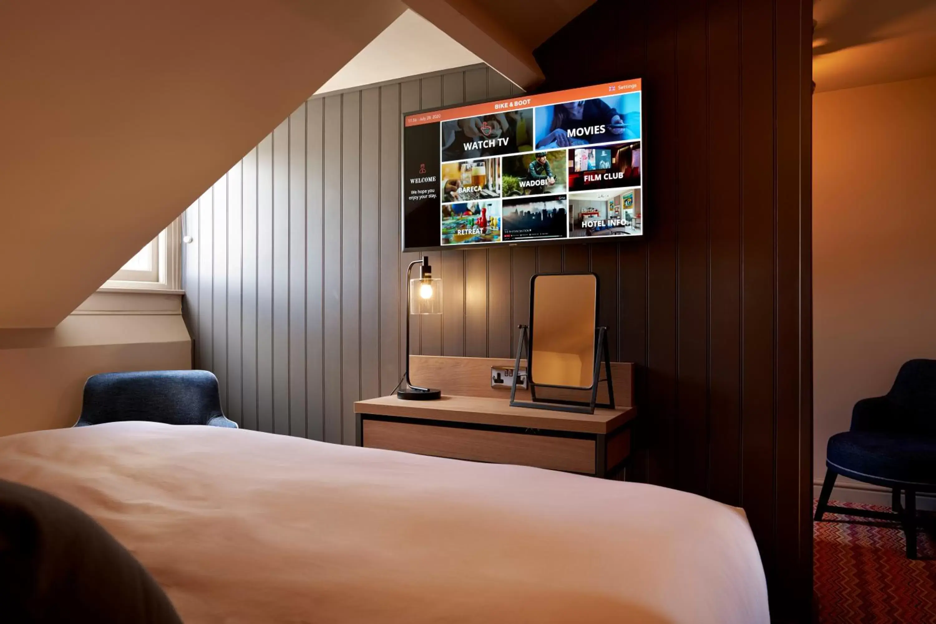 Bedroom, TV/Entertainment Center in The Bike & Boot Hotel