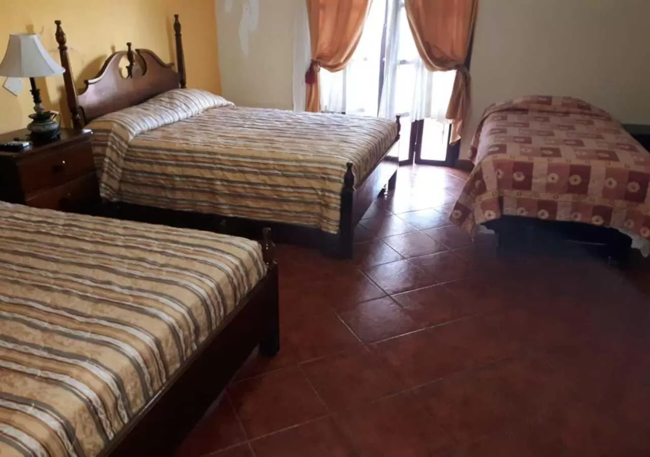 Bed in Hotel Acropolis Maya