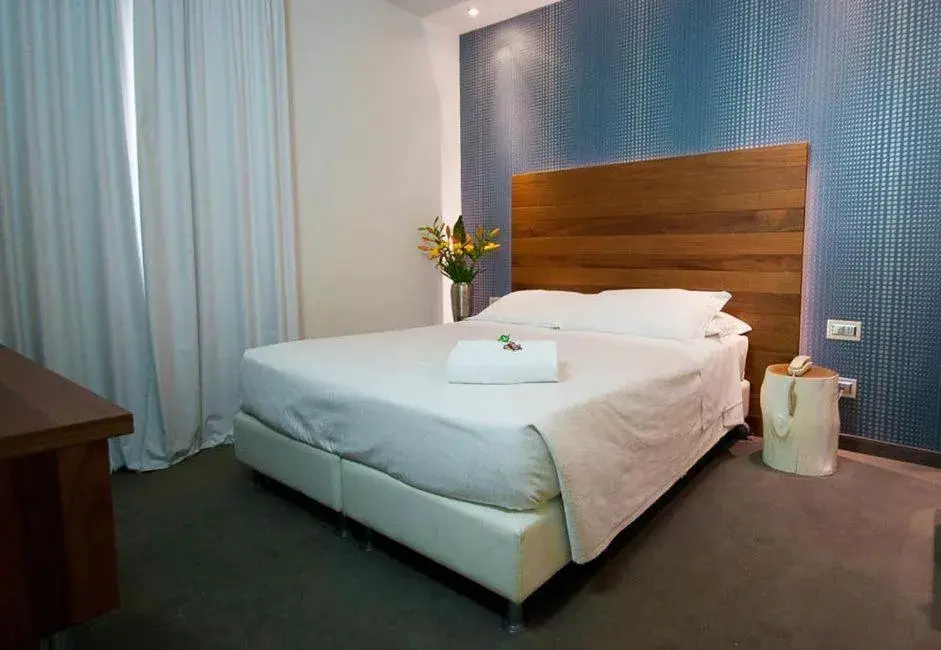 Bed in Q Hotel