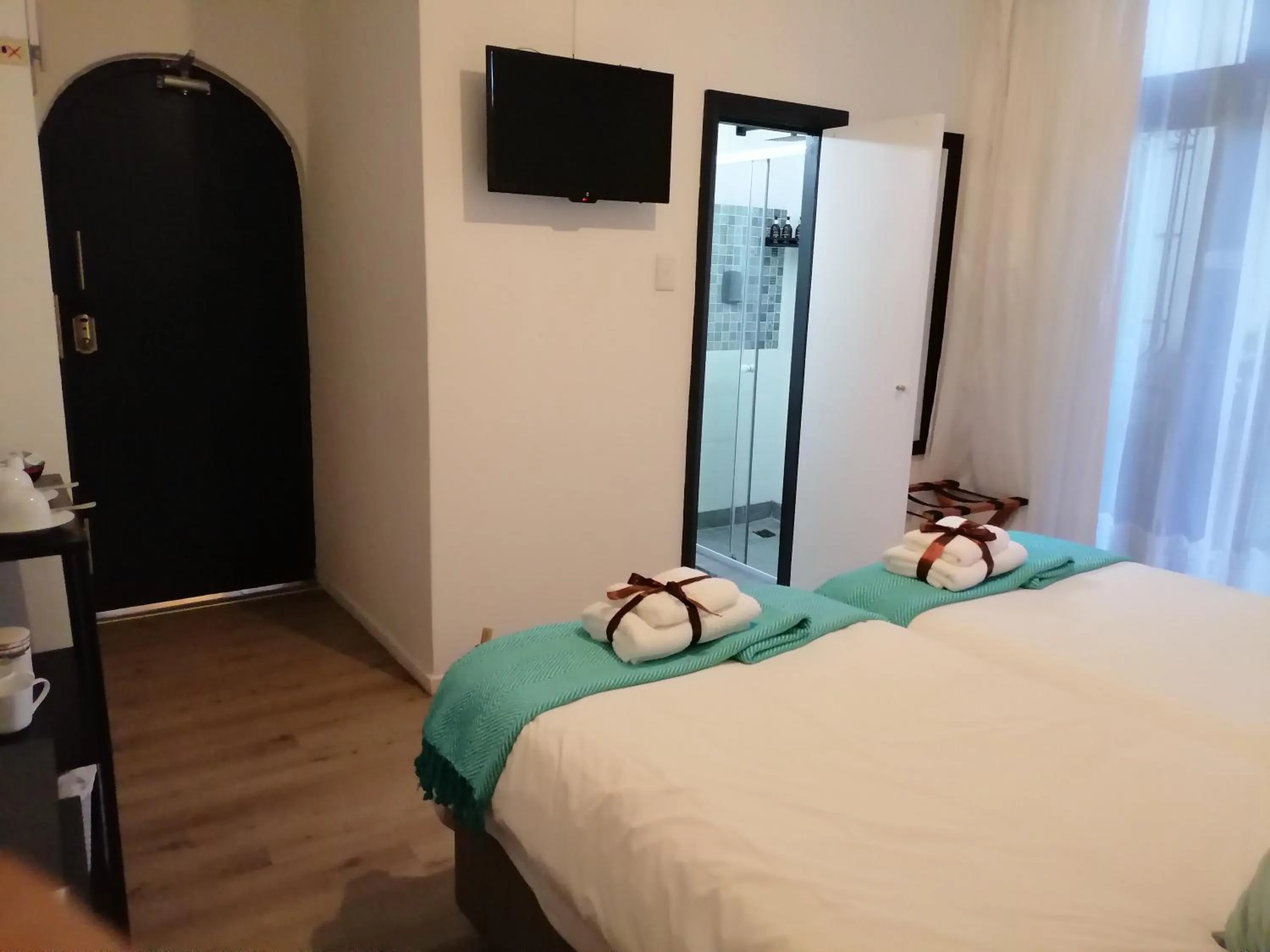 Bed in Point B Guest House -Sustainable Solar Energy