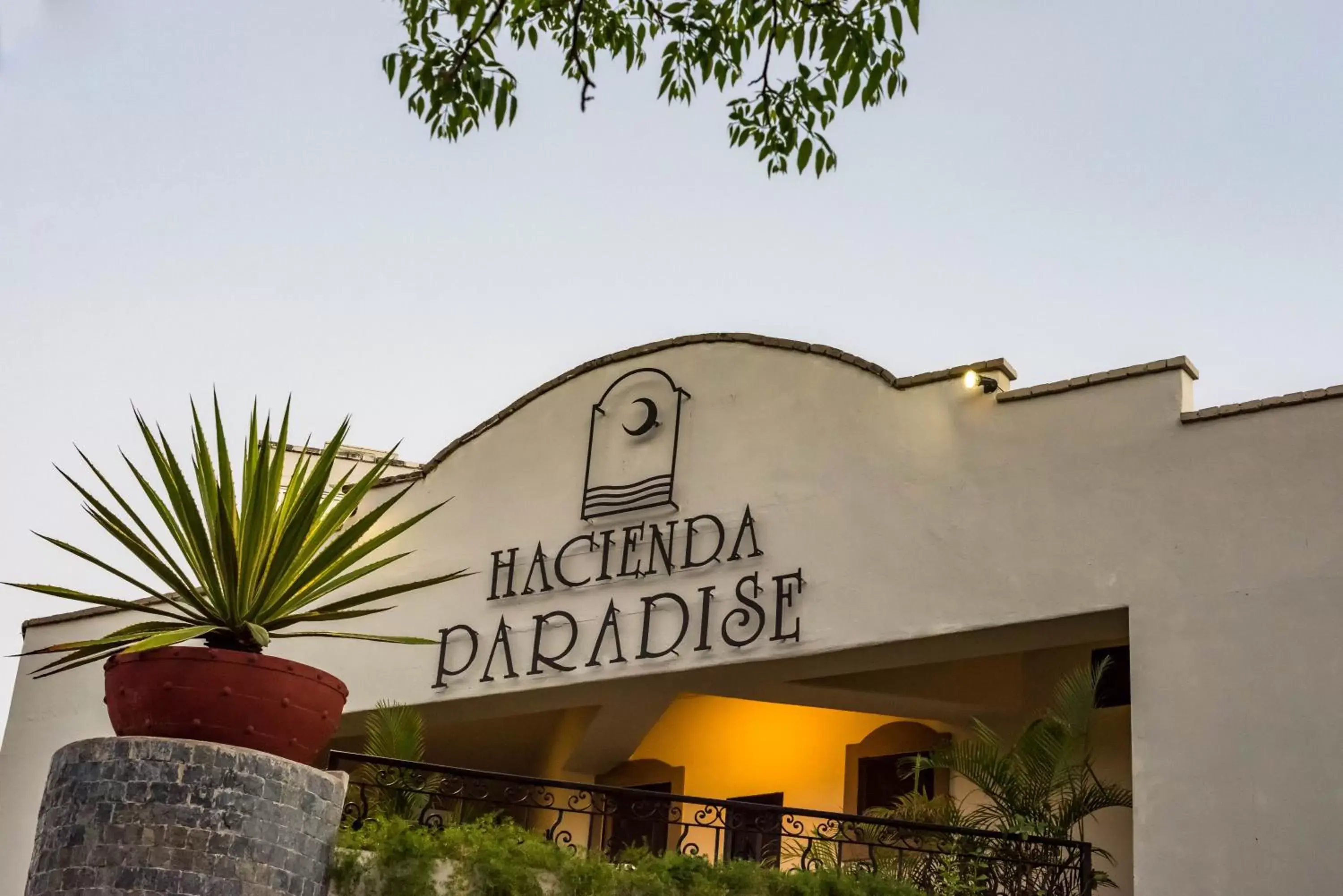 Property logo or sign in Hacienda Paradise Hotel by BFH