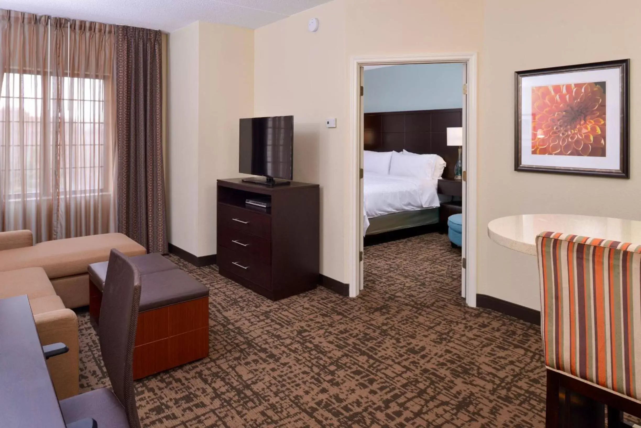 Bed, TV/Entertainment Center in Staybridge Suites Indianapolis-Fishers, an IHG Hotel