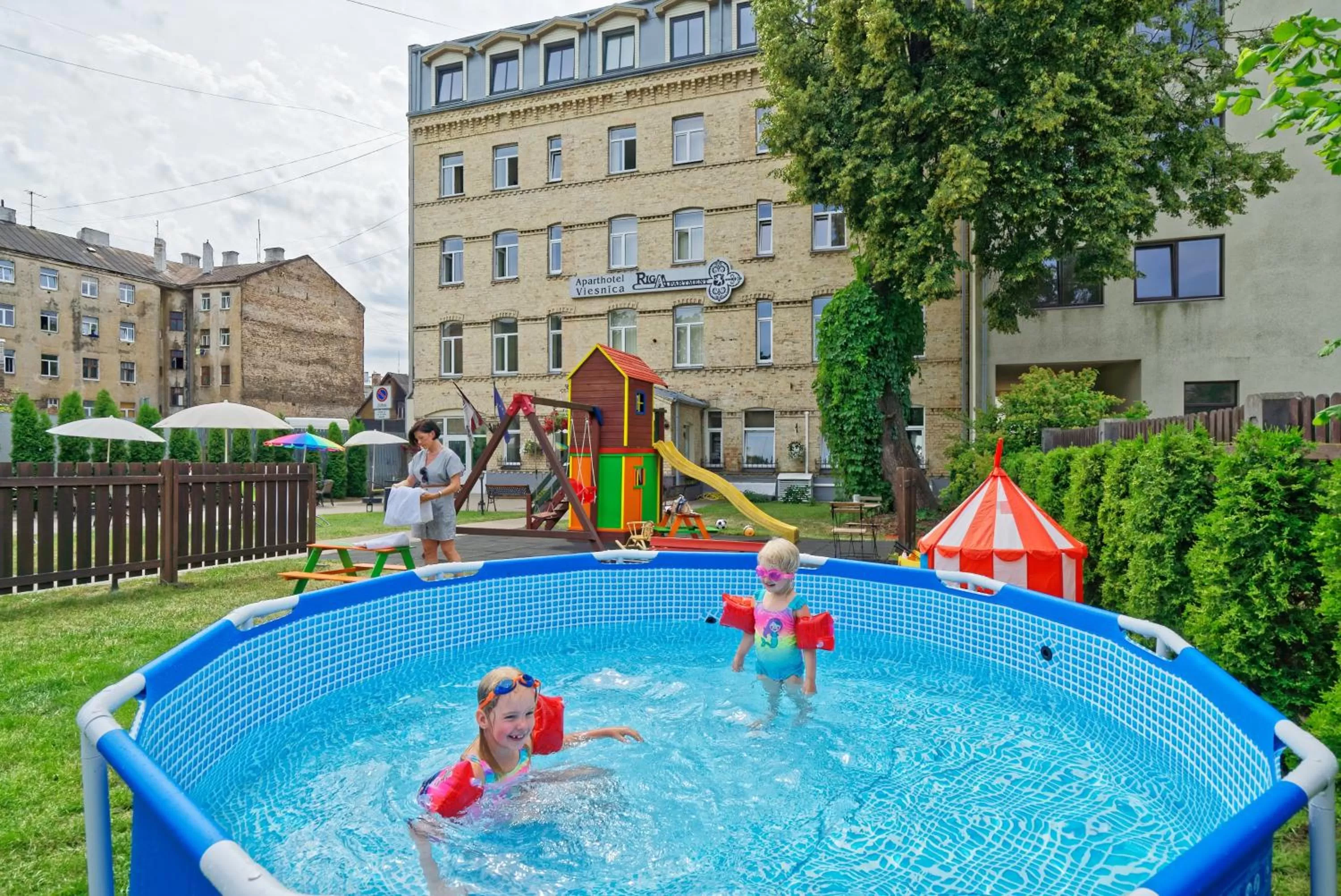 Children play ground in RIGAAPARTMENT SONADA Family Aparthotel - Private Parking