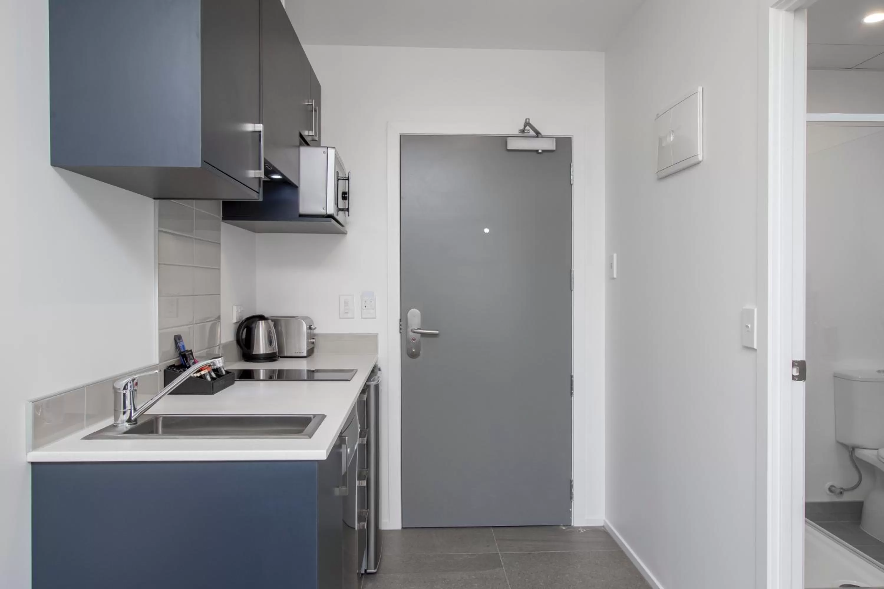 Kitchen or kitchenette in Ramada Suites by Wyndham Auckland Manukau Pacfic Centre
