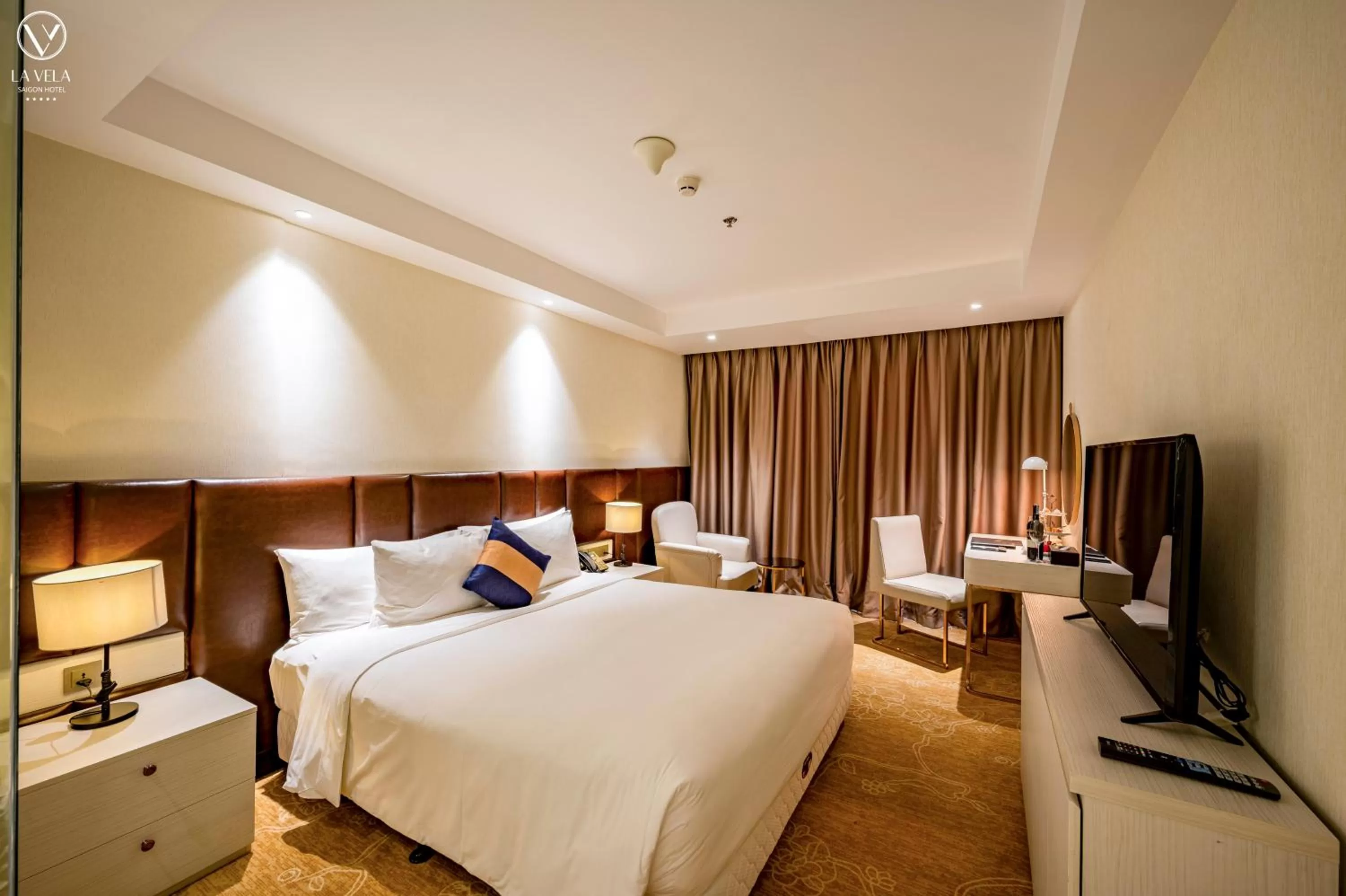 Bed in La Vela Saigon Hotel