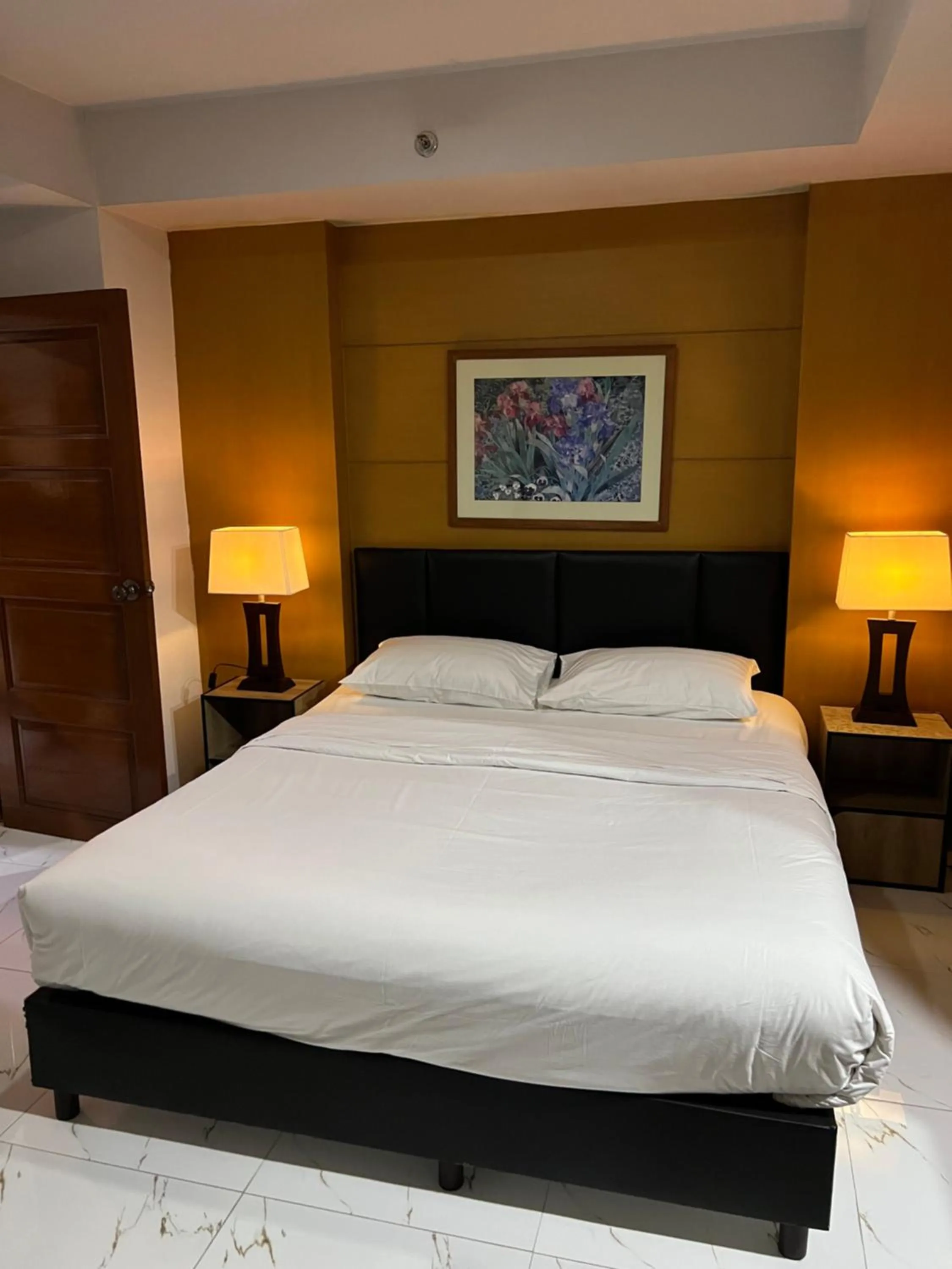 Bed in Mall Suites Hotel