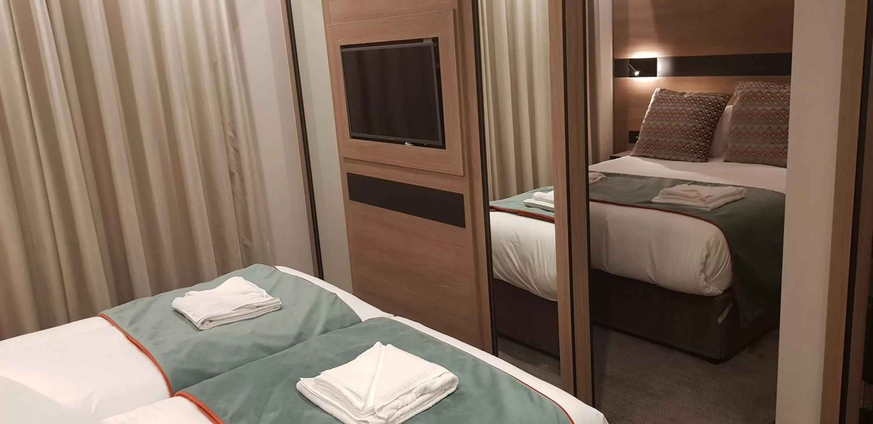 Bed in Merit Kensington Hotel