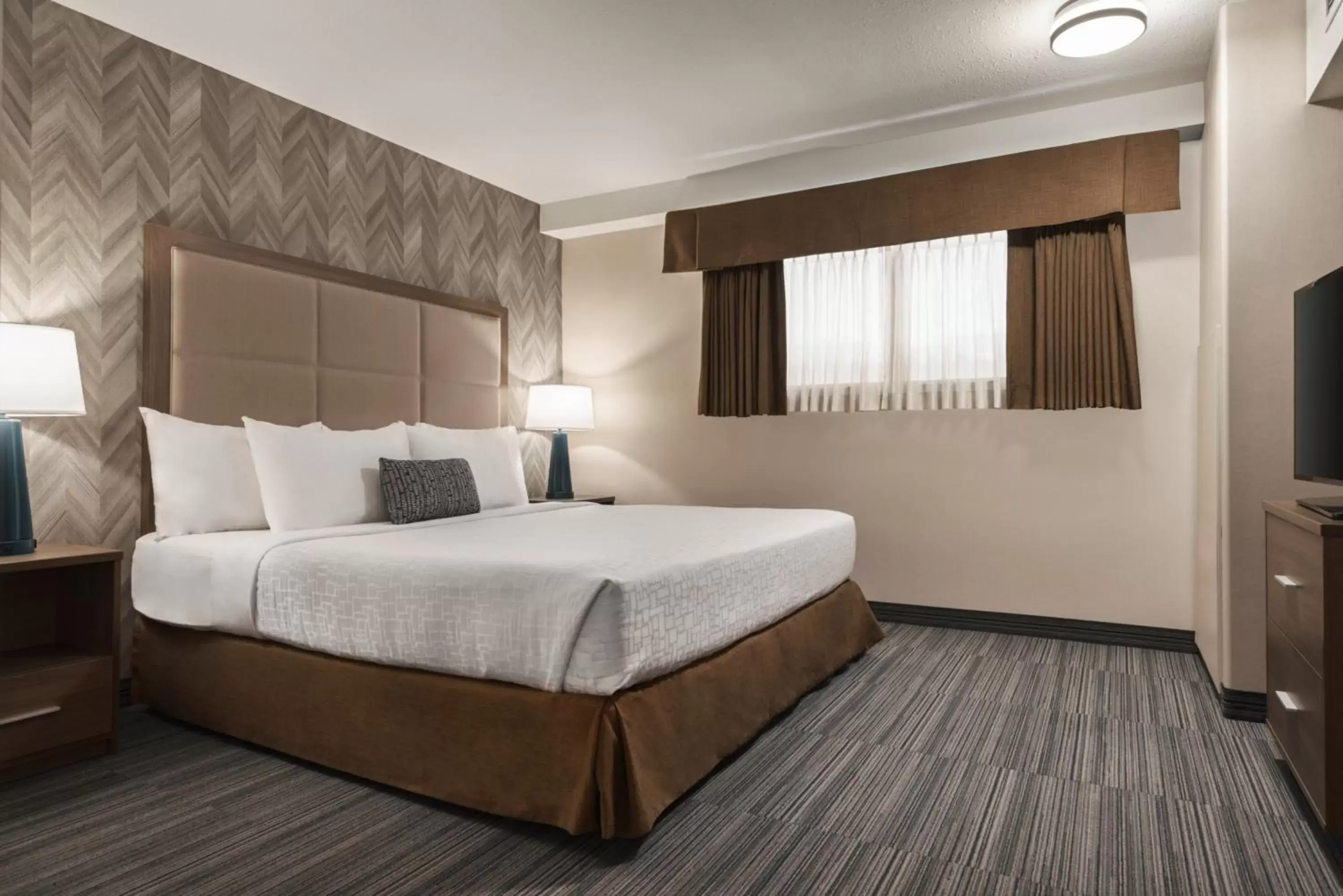 Bedroom, Bed in Ramada by Wyndham Airdrie Hotel & Suites