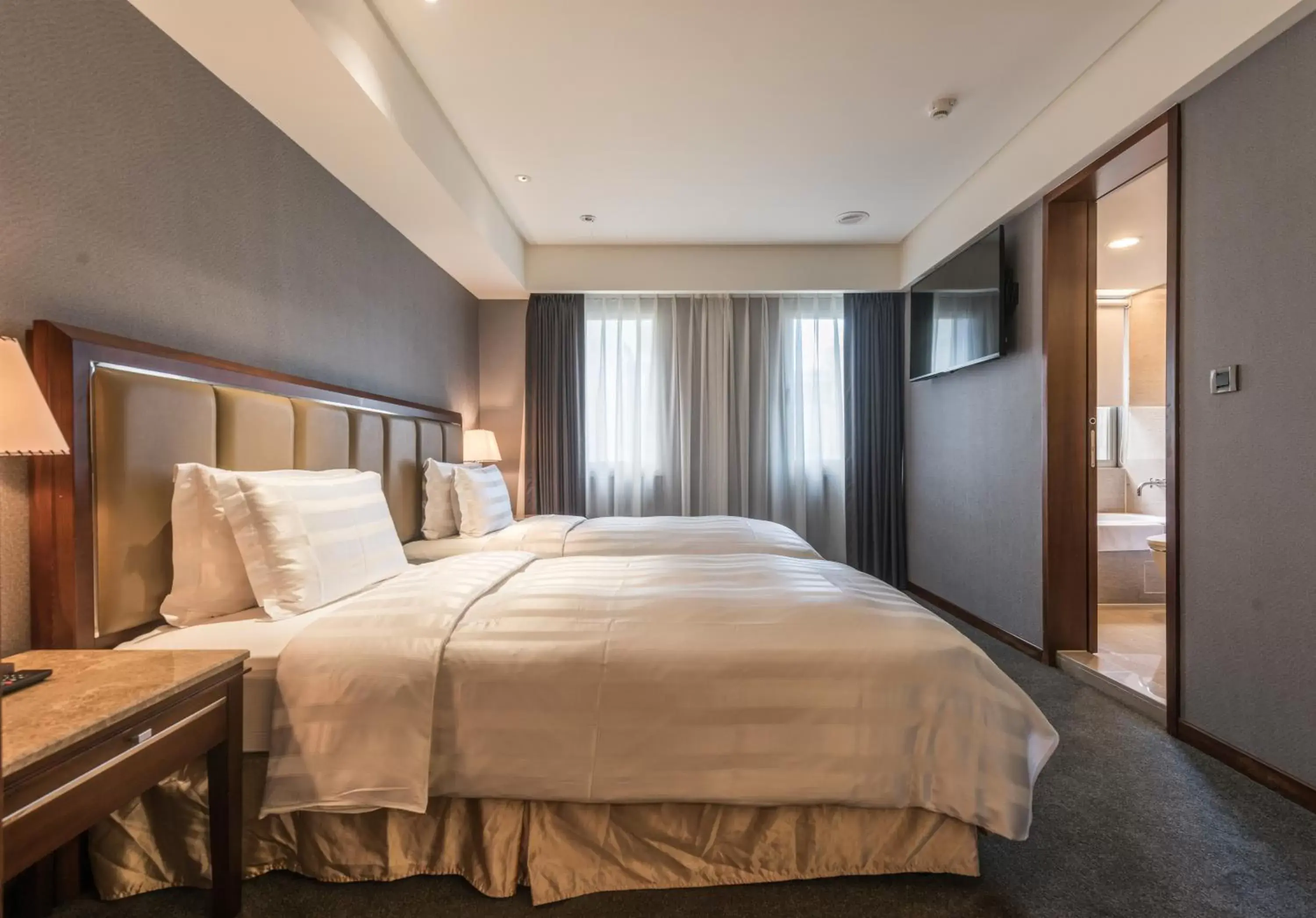 Bed in Royal Biz Taipei Hotel