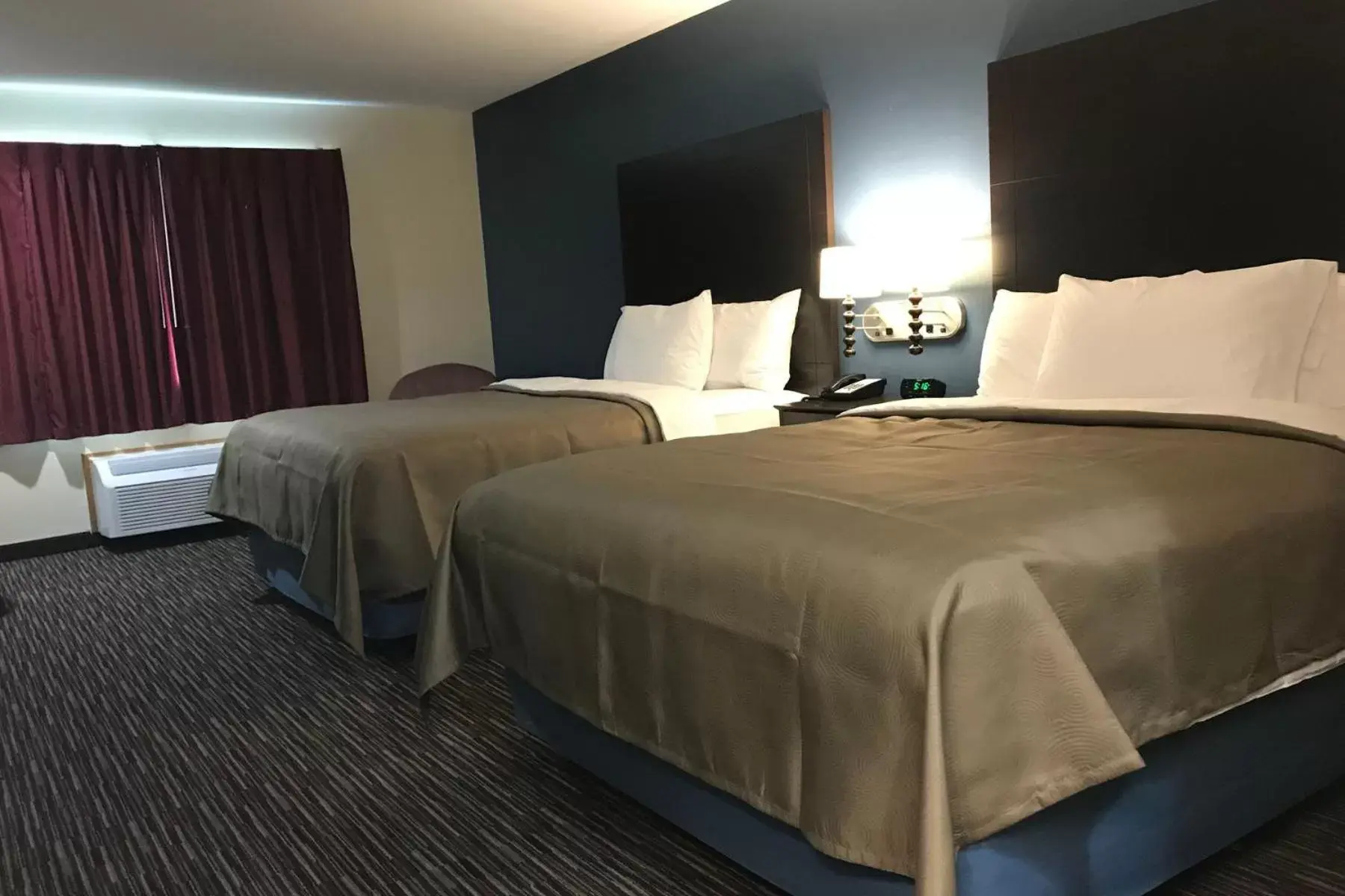 Bed in AmericInn by Wyndham Jefferson