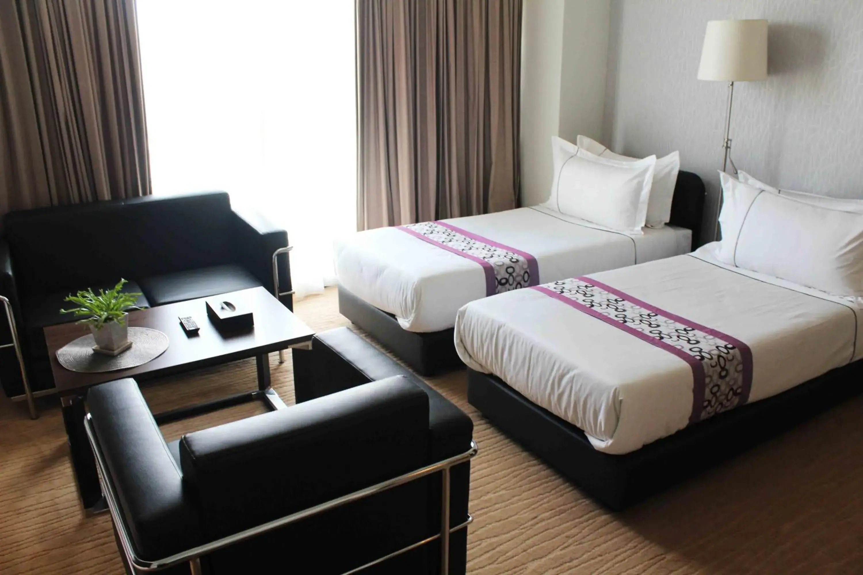 Bed in Symphony Suites Hotel