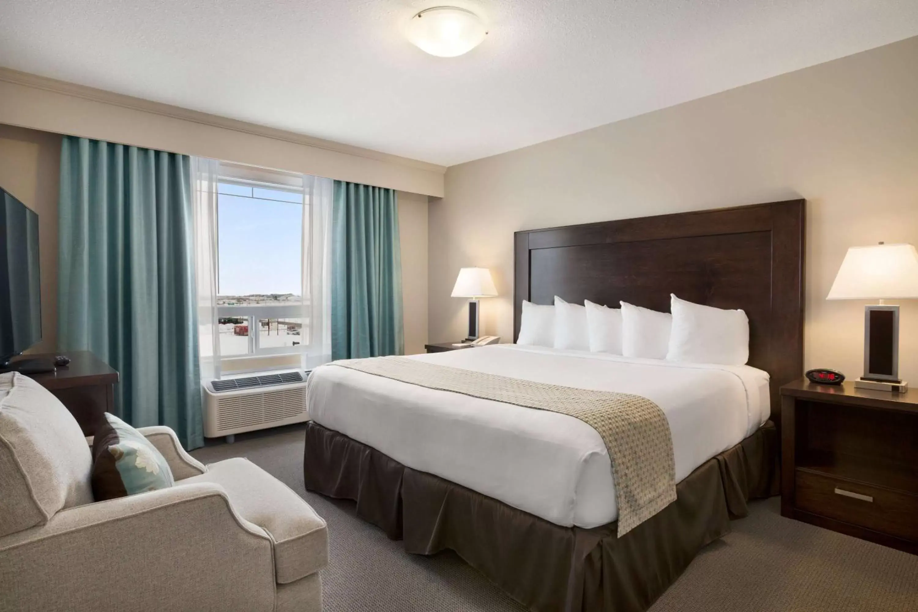Photo of the whole room, Bed in Ramada by Wyndham Emerald Park/Regina East