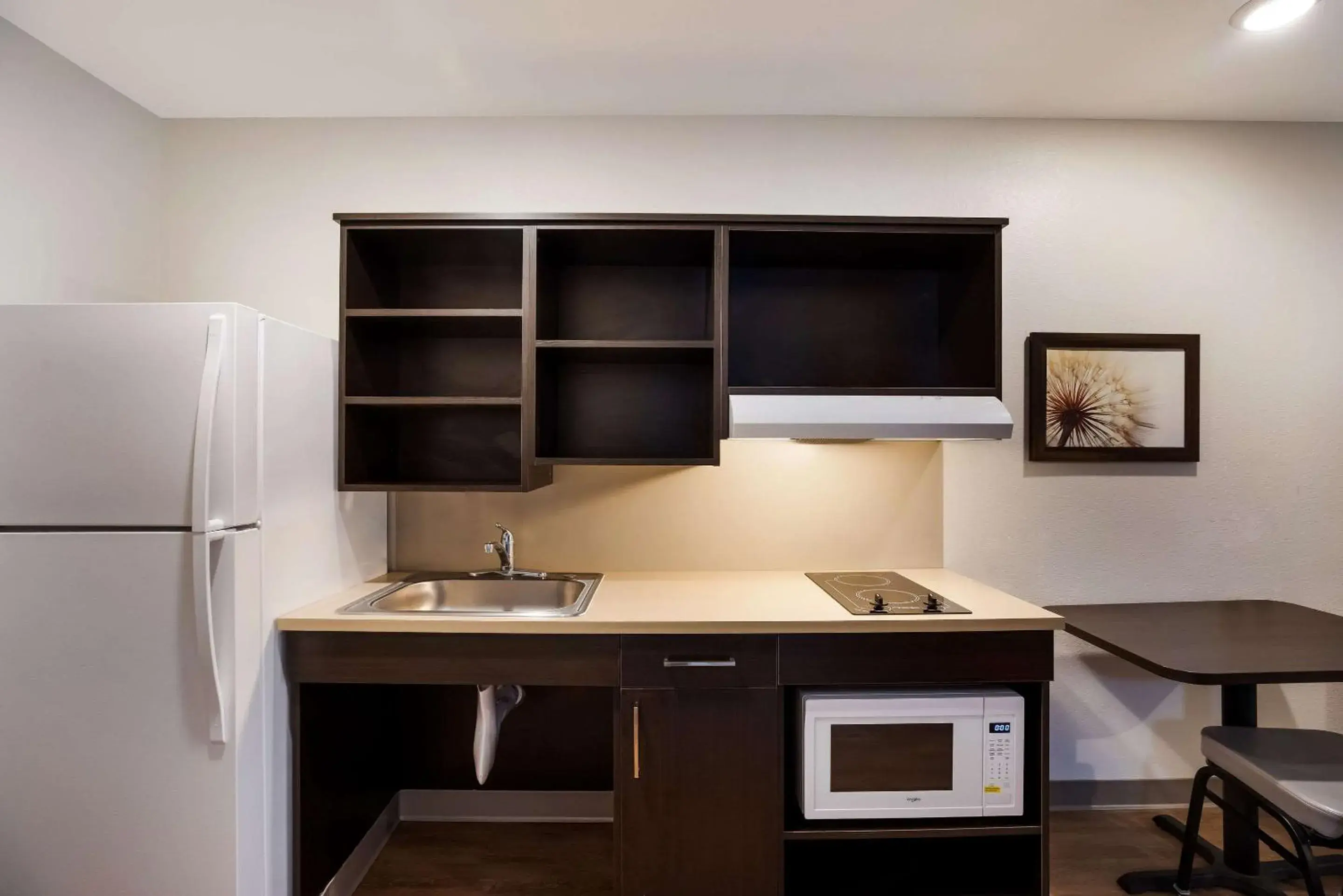 Bedroom, Kitchen/Kitchenette in WoodSpring Suites Orlando North - Maitland