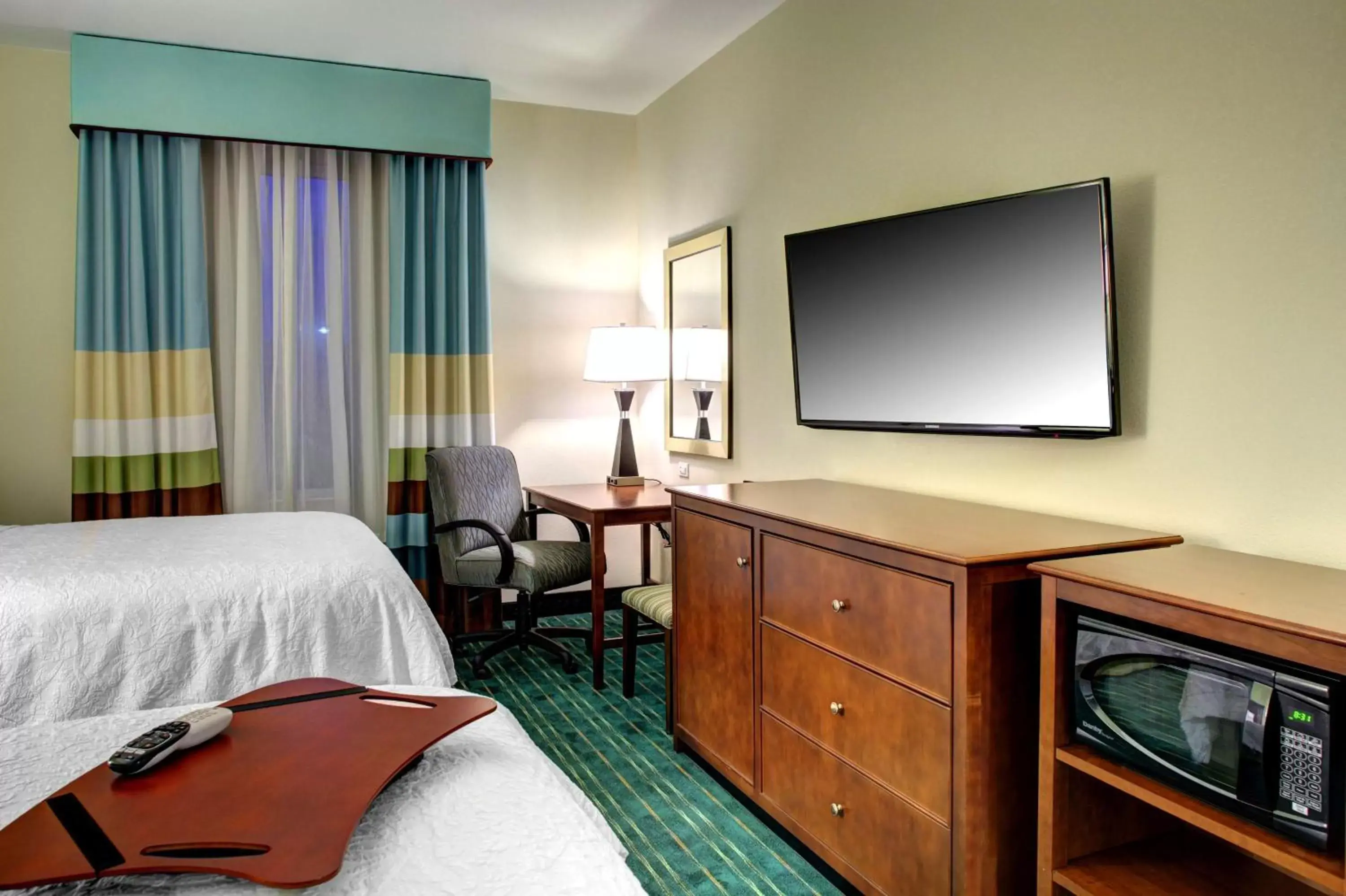 Bed, TV/Entertainment Center in Hampton Inn and Suites Coconut Creek