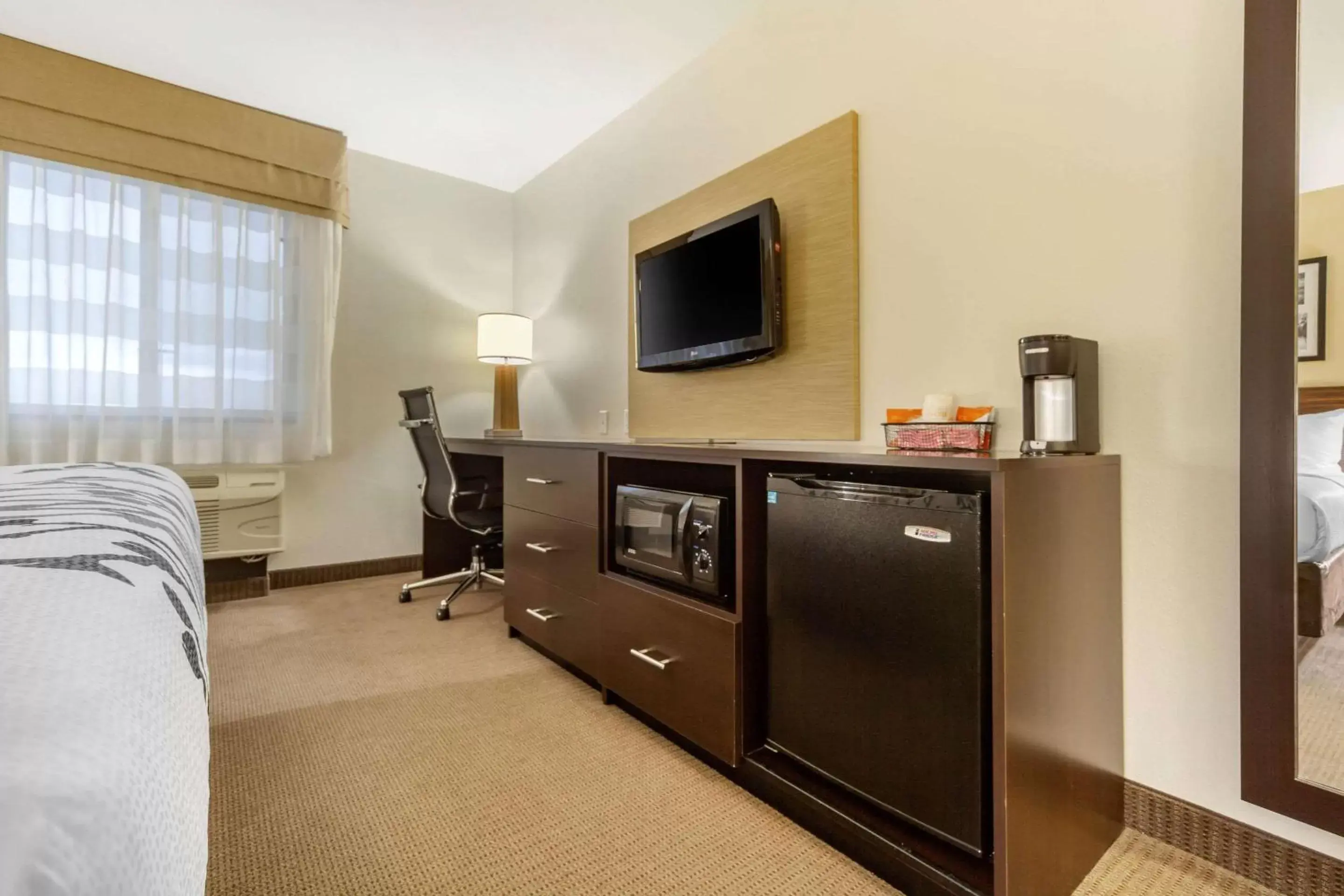 Photo of the whole room, TV/Entertainment Center in Sleep Inn & Suites Grand Forks Alerus Center