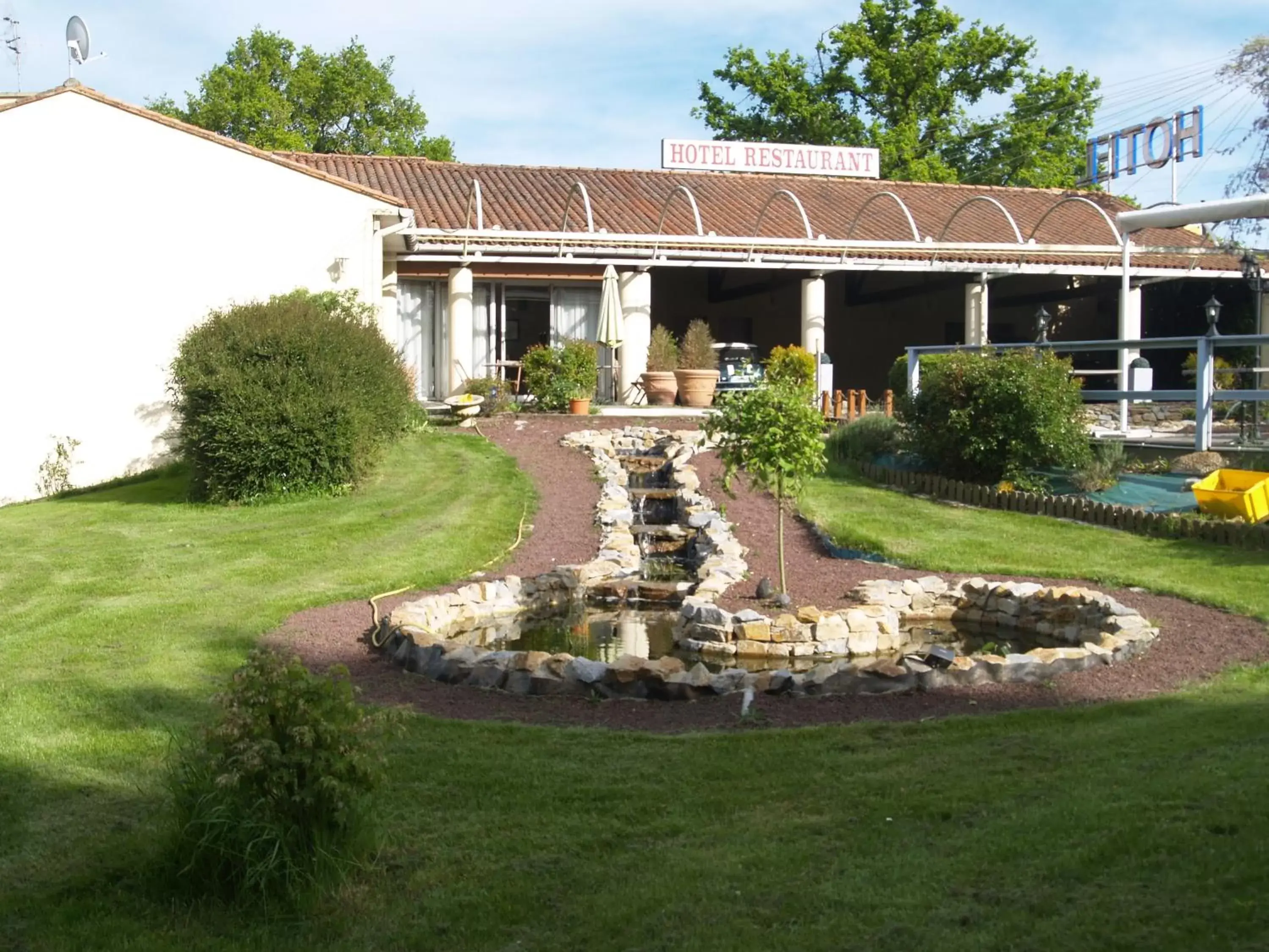 Garden view, Property Building in Hôtel Au Relais des Lilas