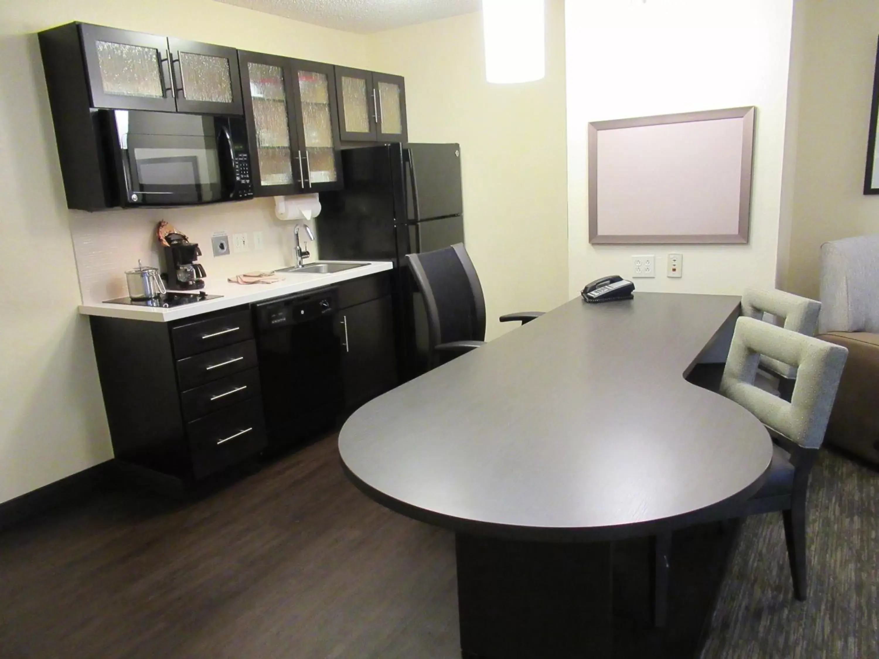 Bedroom, Kitchen/Kitchenette in Candlewood Suites Lake Mary, an IHG Hotel