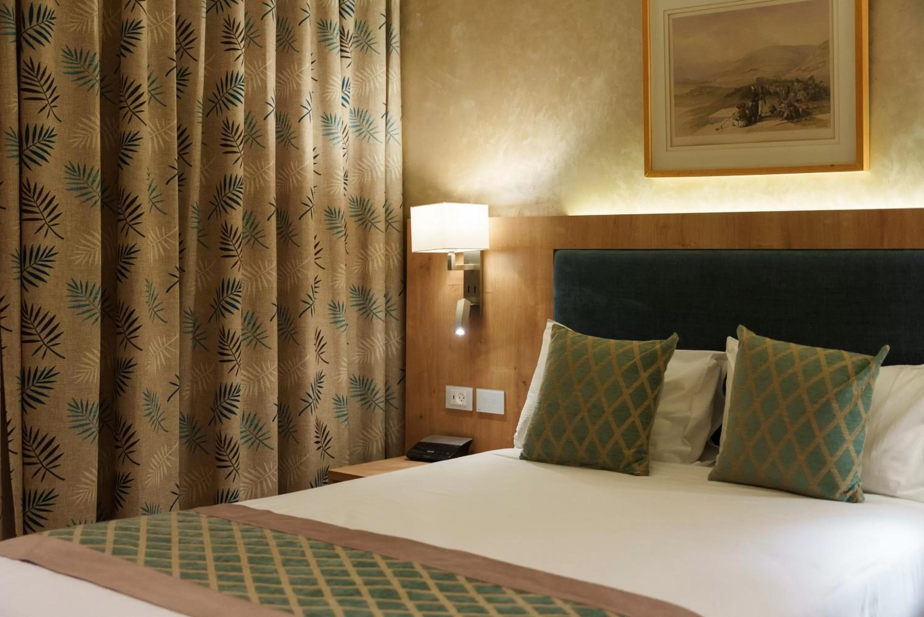 Bed in Ambassador Boutique Hotel