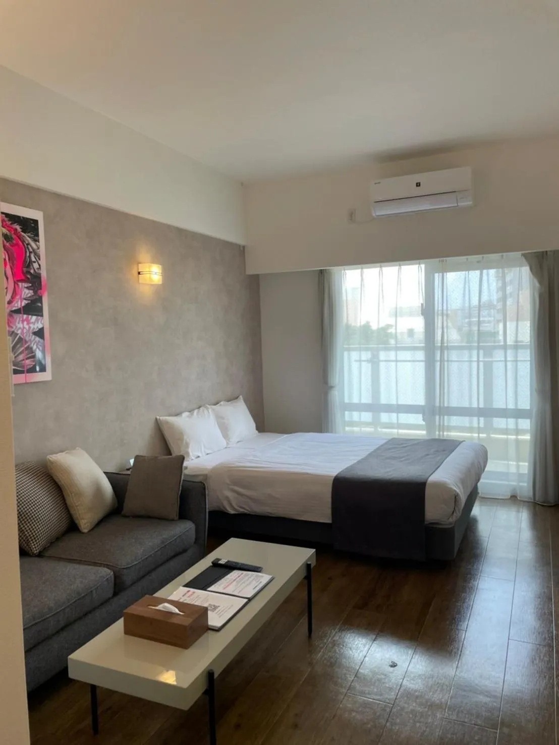 Photo of the whole room, Bed in New Normal Hotel in NAMINOUE ニューノーマルホテルイン波の上