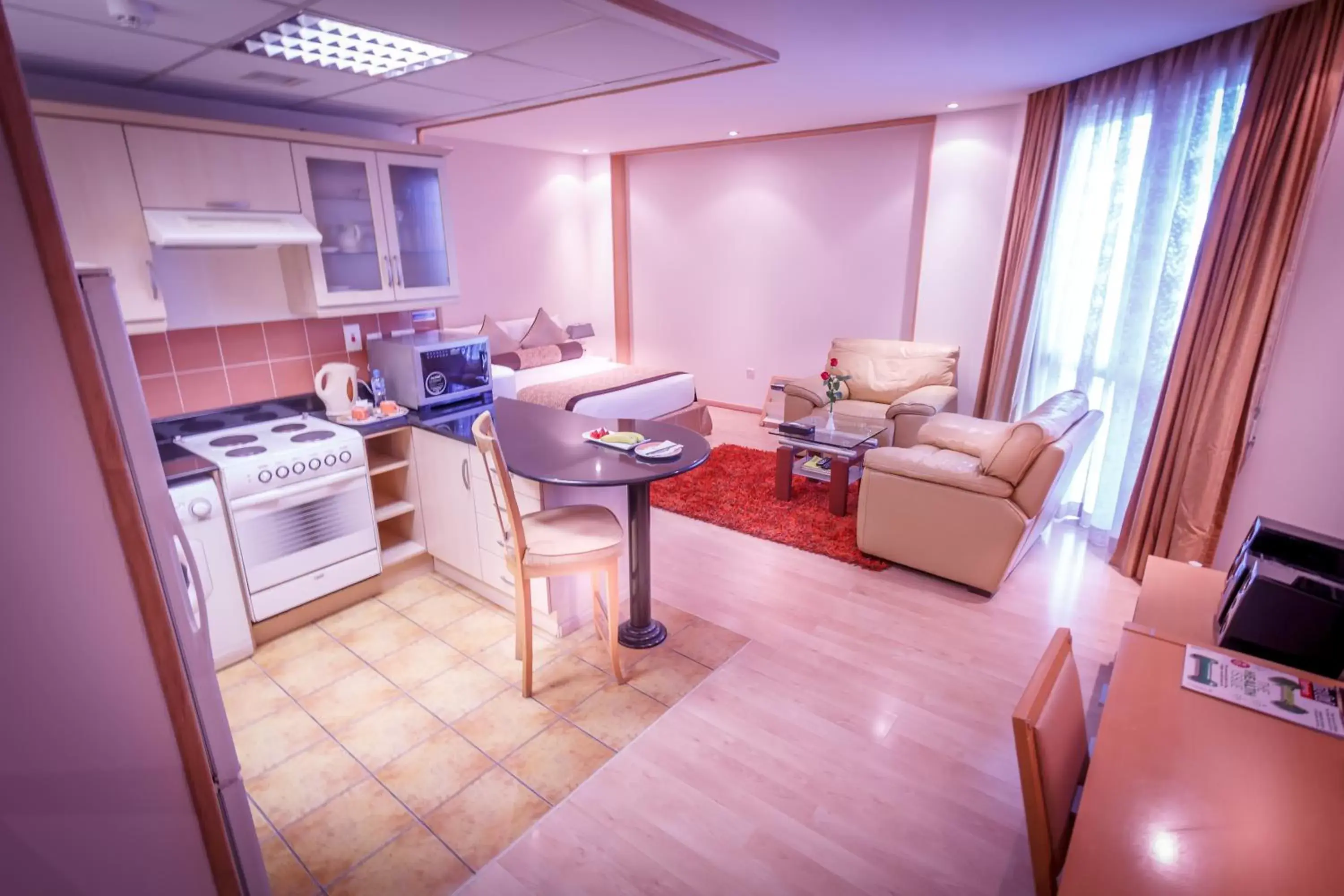 Living room, Kitchen/Kitchenette in Elite Seef Residence And Hotel
