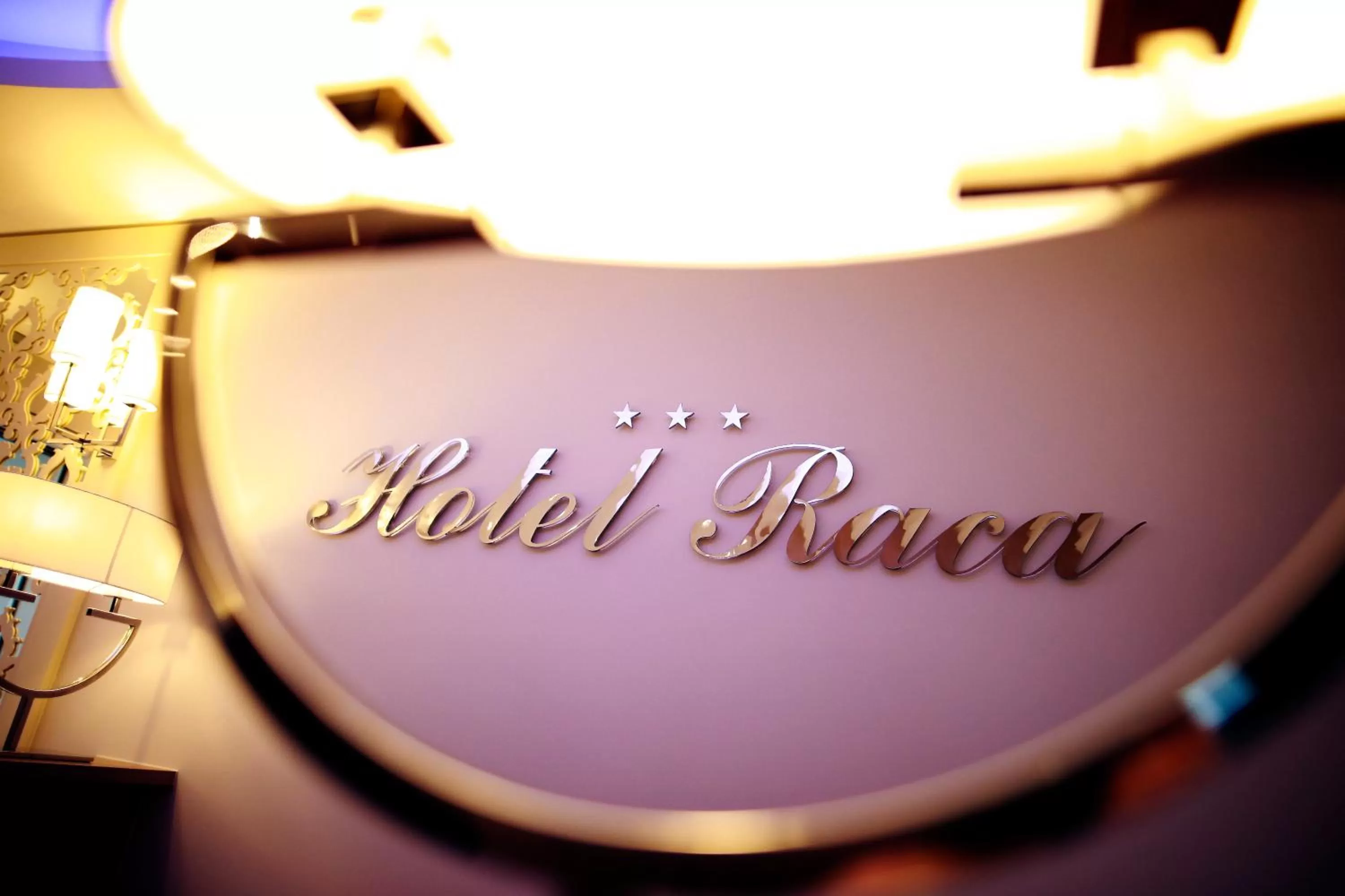 Property logo or sign in Hotel Raca