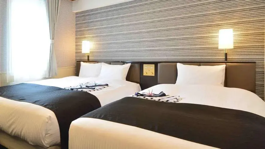Bed in APA Hotel Beppu Ekimae Bed in APA Hotel Beppu Ekimae
