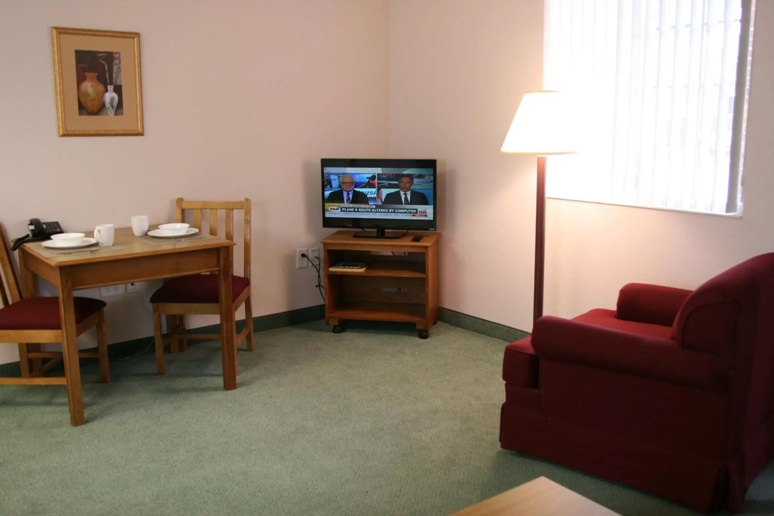 Seating area, TV/Entertainment Center in Affordable Suites Rocky Mount