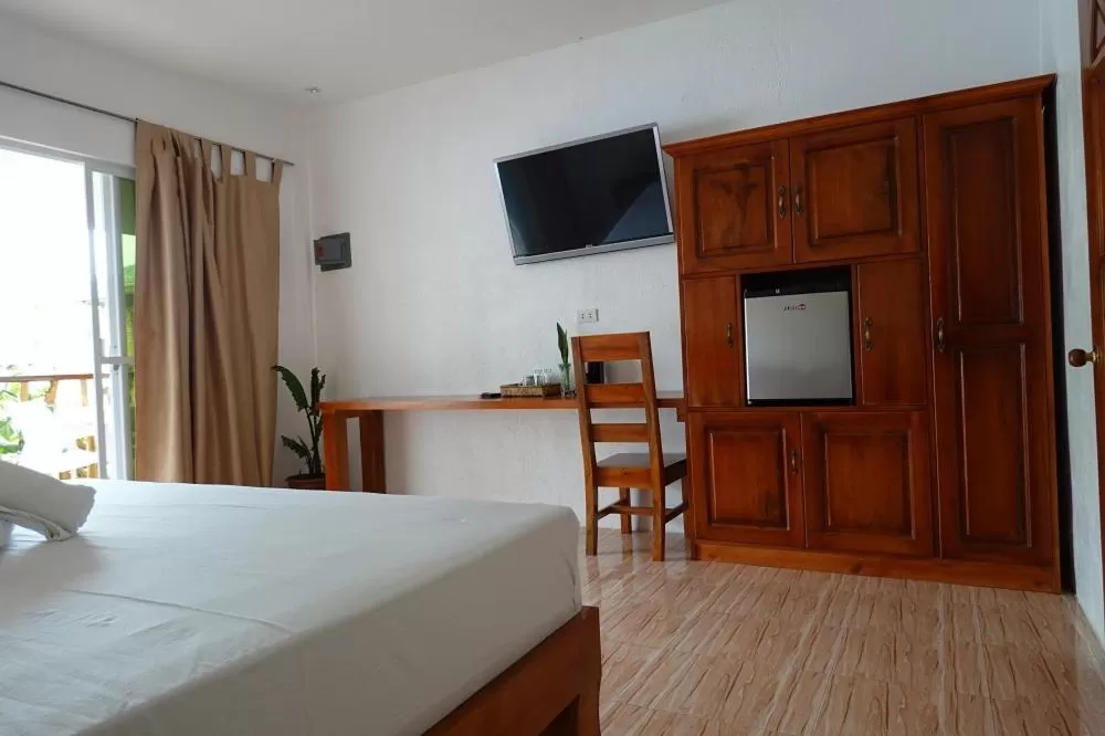 Bed, TV/Entertainment Center in Becano Restobar and Resort