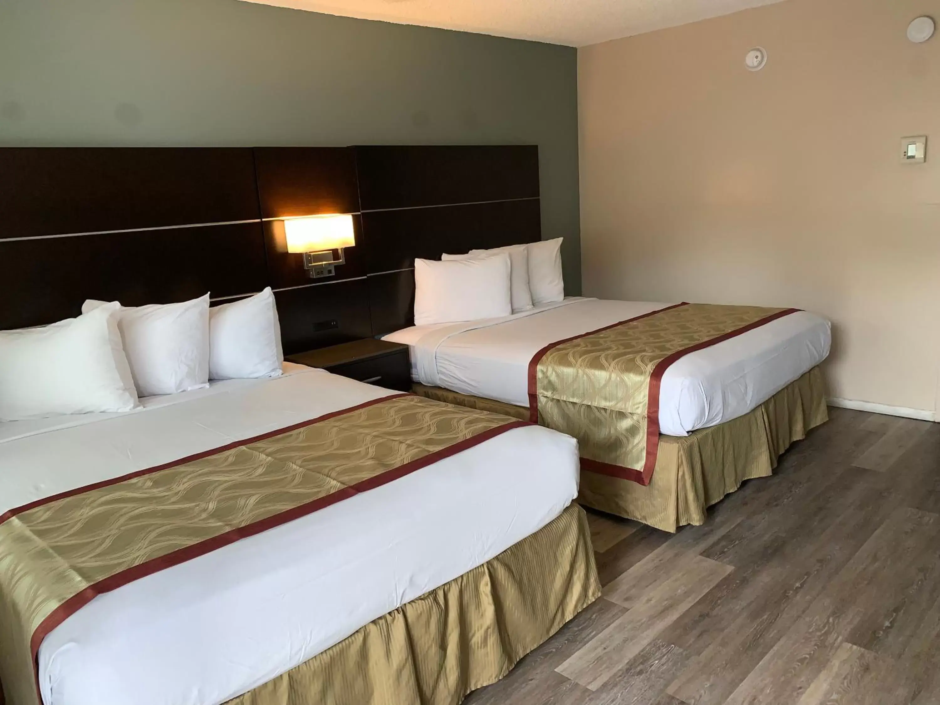 Bed in Olive Tree Inn & Suites
