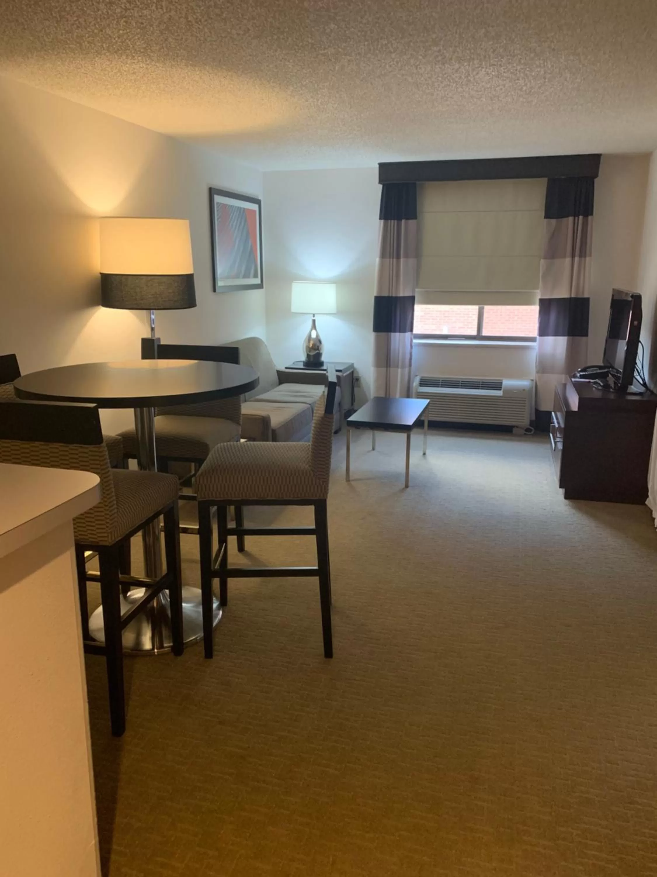 Seating area, Bed in Ramada by Wyndham Marquette