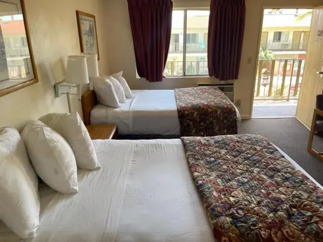 Bed in California Suites Hotel