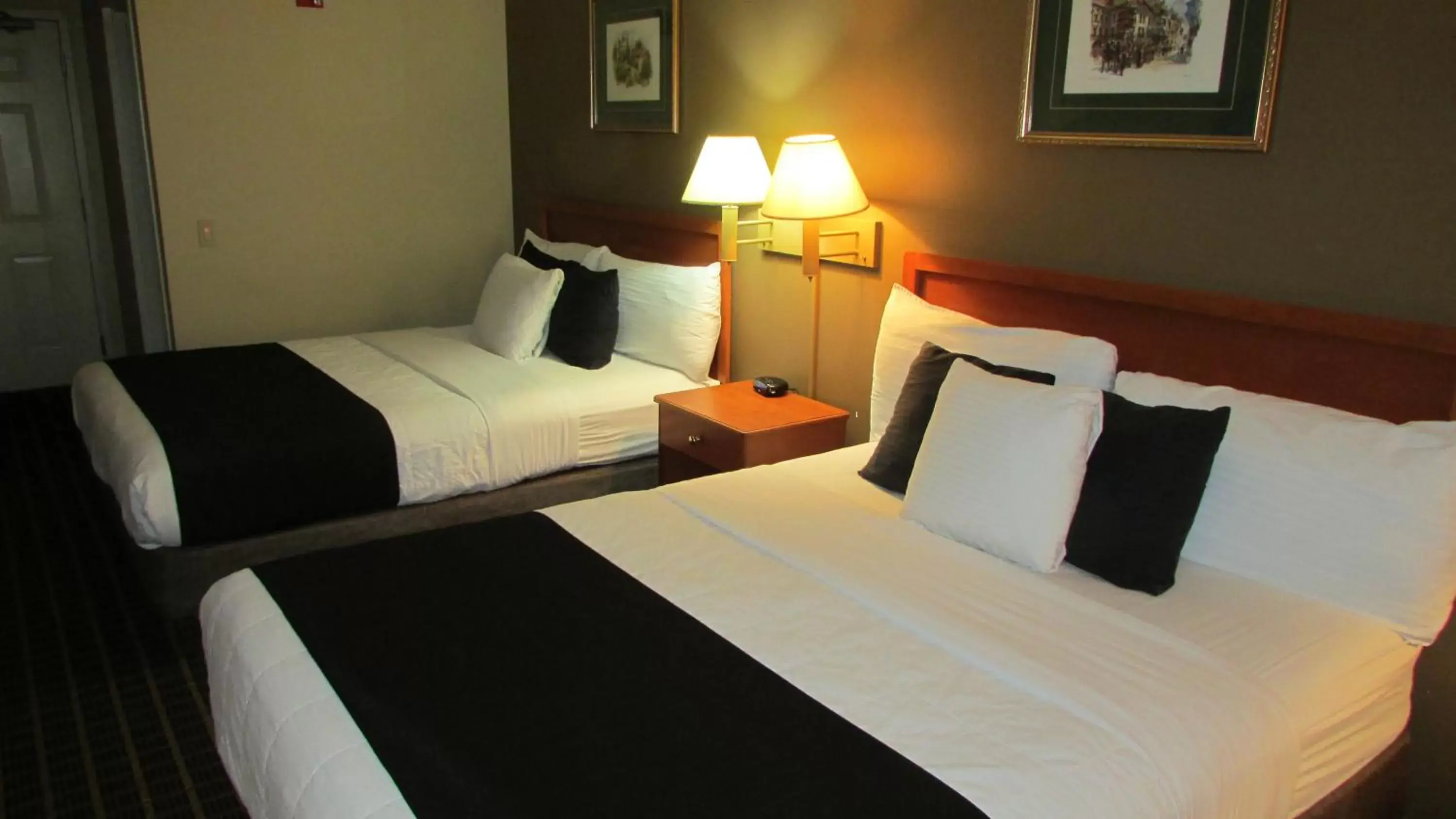 Bed in FairBridge Inn & Suites