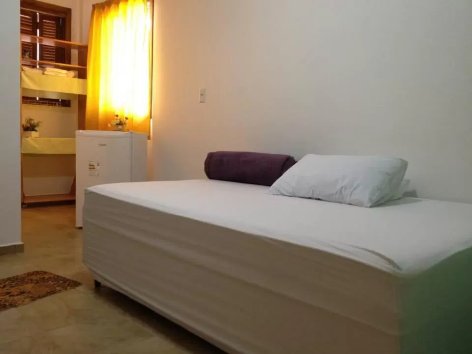 Bed in Hotel Pousada Rolantchê