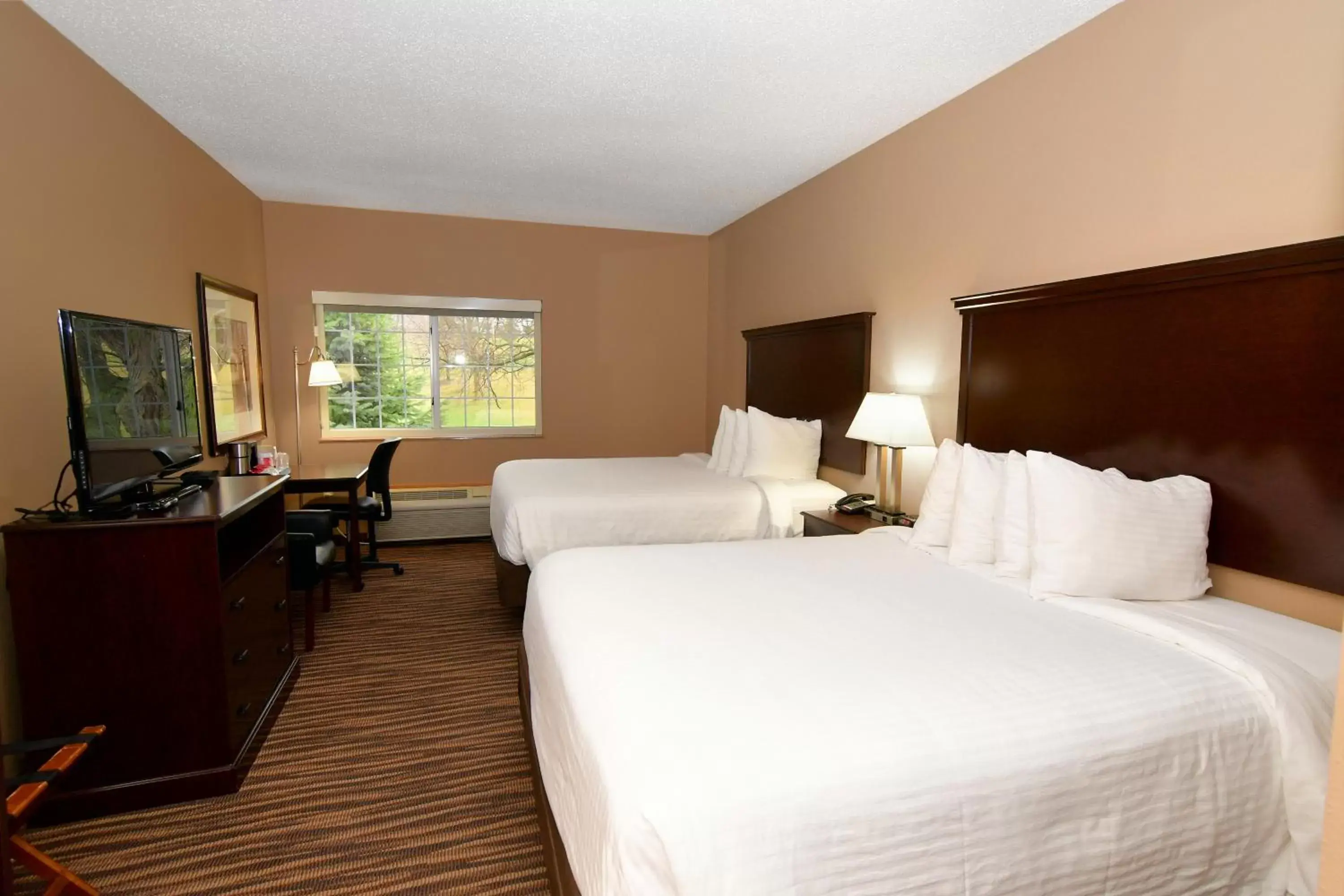 Bed in Cobblestone Inn & Suites - Denison | Majestic Hills