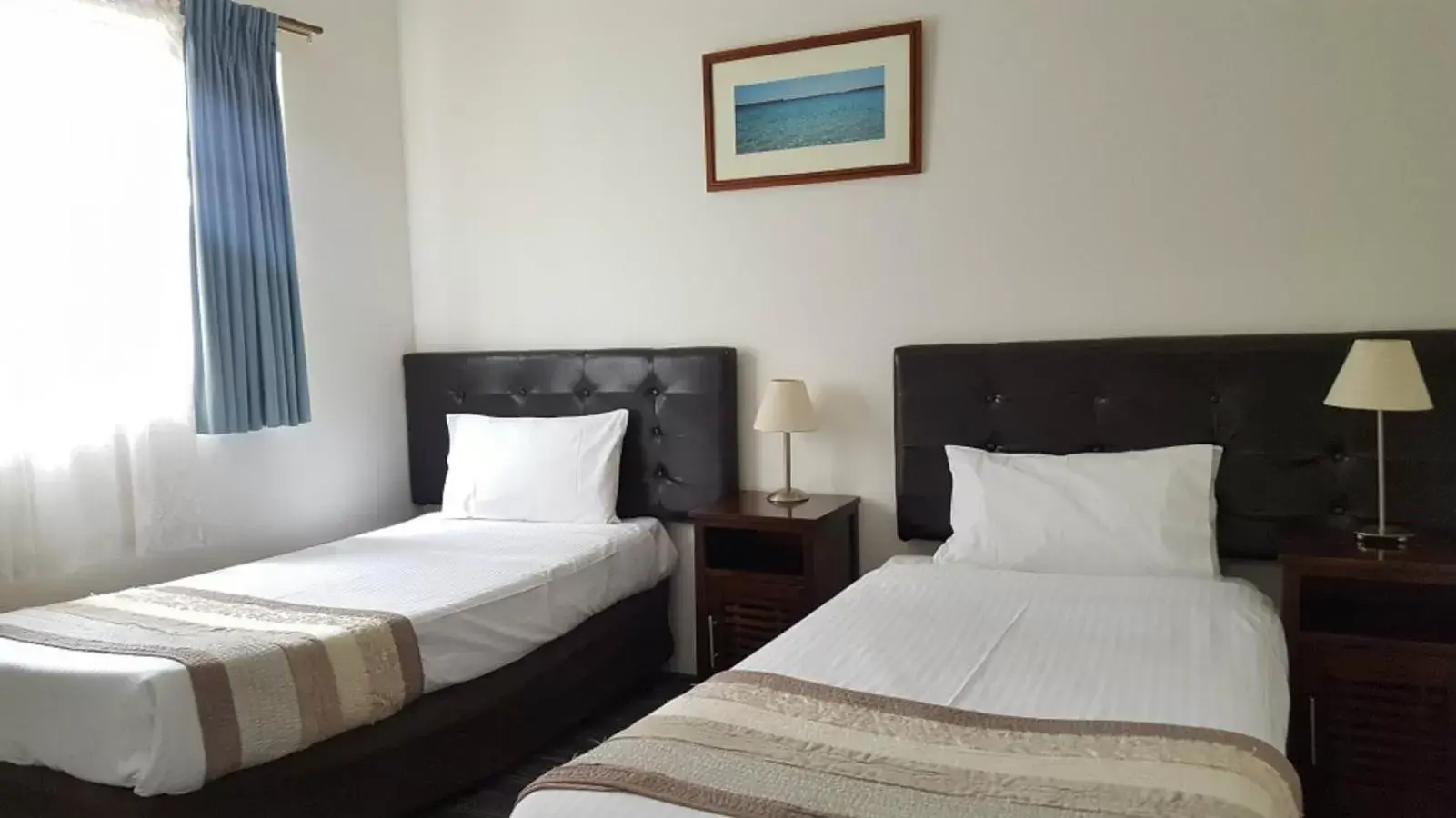 Bed in Sanctuary Resort Motor Inn