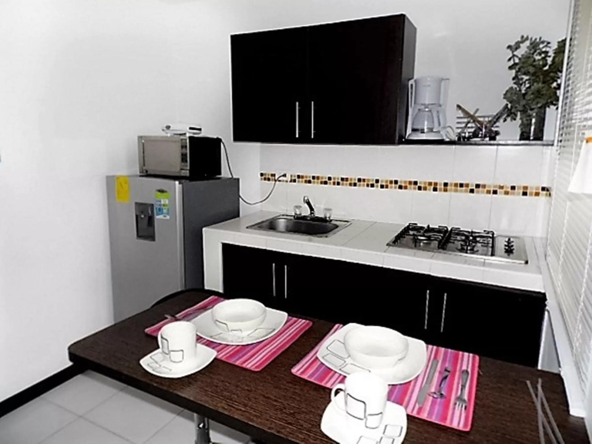 Kitchen or kitchenette in Apartasuites San Marcos